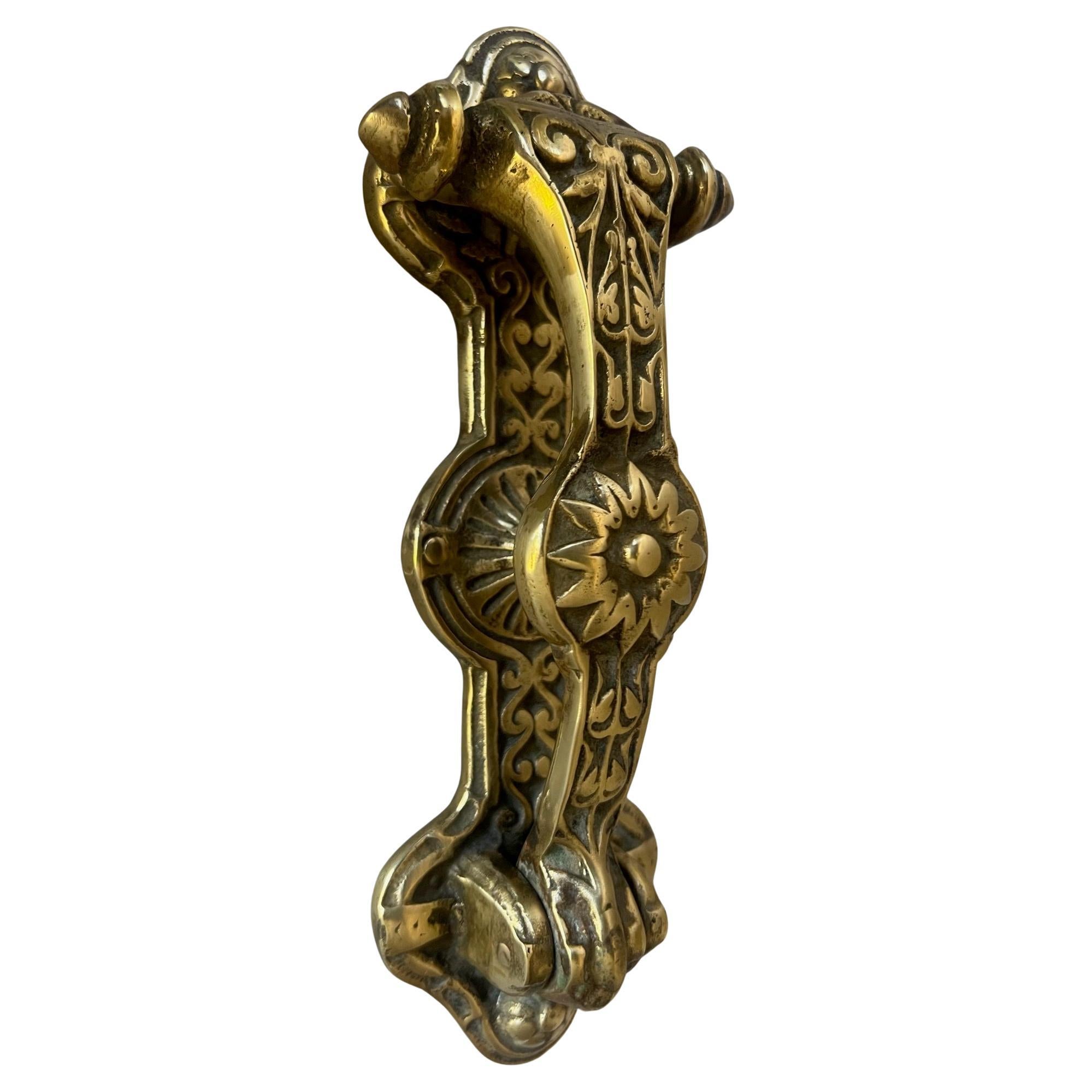 19th century English brass door knocker with sunflower motif in the center. 