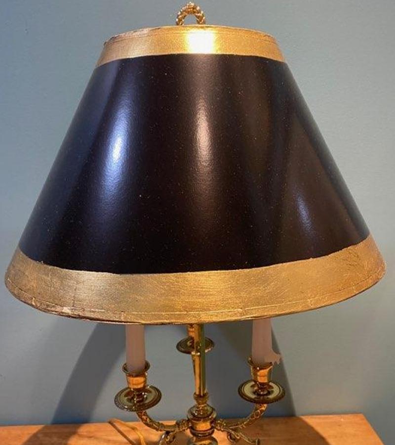 19th century Brass Three Arm Bouillotte Lamp with Hand Painted Metal Shade. The shade is painted black with gold rim. Lamp itself is gold tone. Wired for modern use with light bulbs and a pull chain to turn on. Candles can still be added to maintain