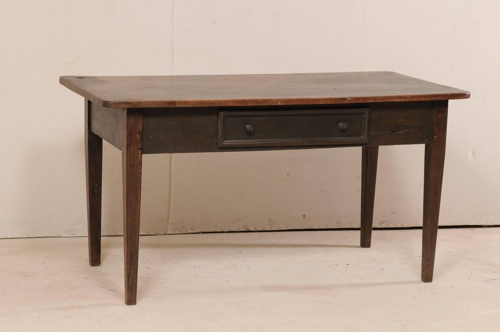 A Brazilian wooden table from the 19th century. This antique Brazilian table has a rectangular-shaped top (which is made from a single board), a clean/plain skirt with single drawer, and is raised upon gently tapered square legs. The table is peroba