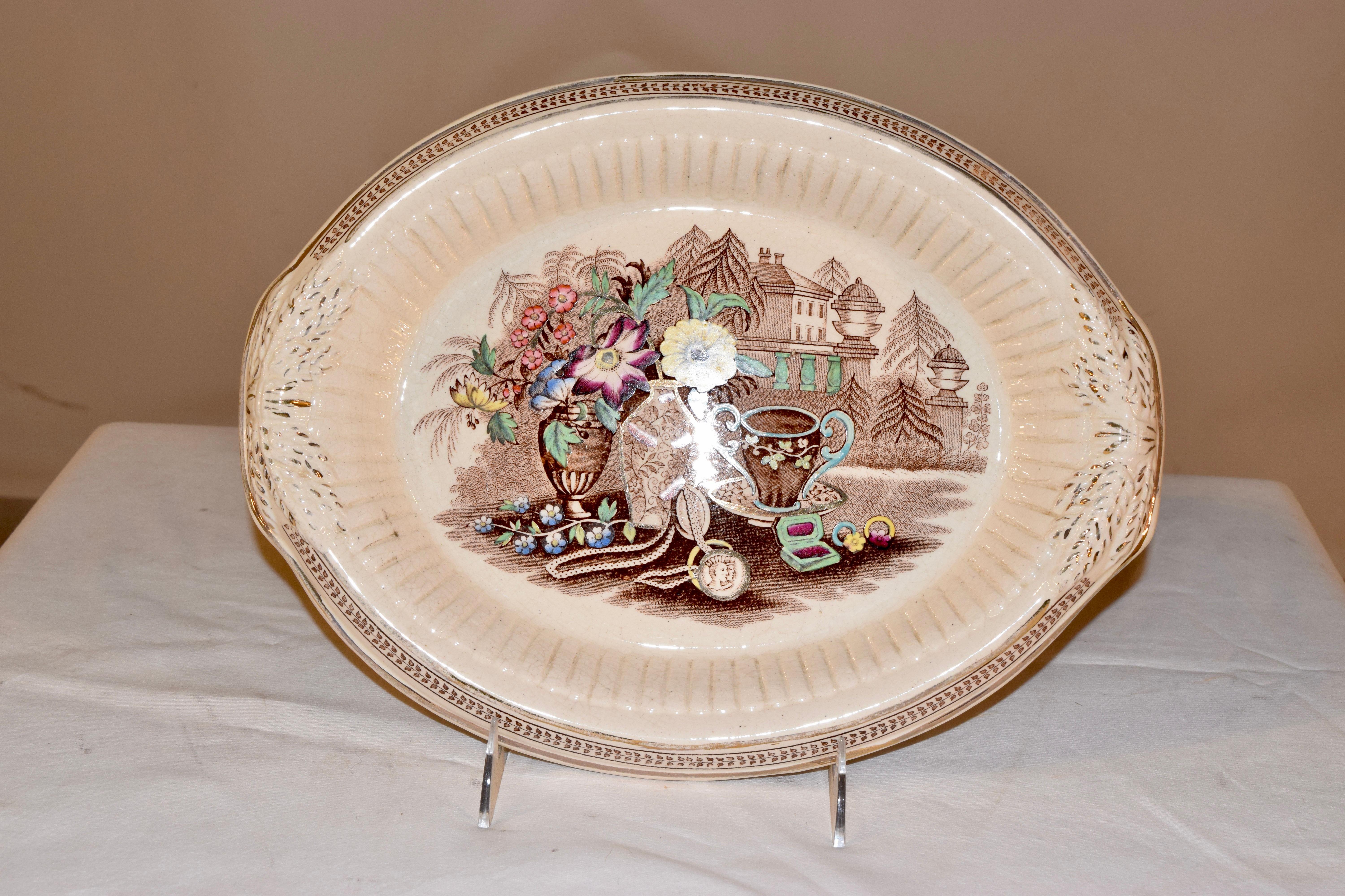 19th century English bread tray with wonderful molded design and brown transfer with polychromed and luster hand painted accents in the central decoration.