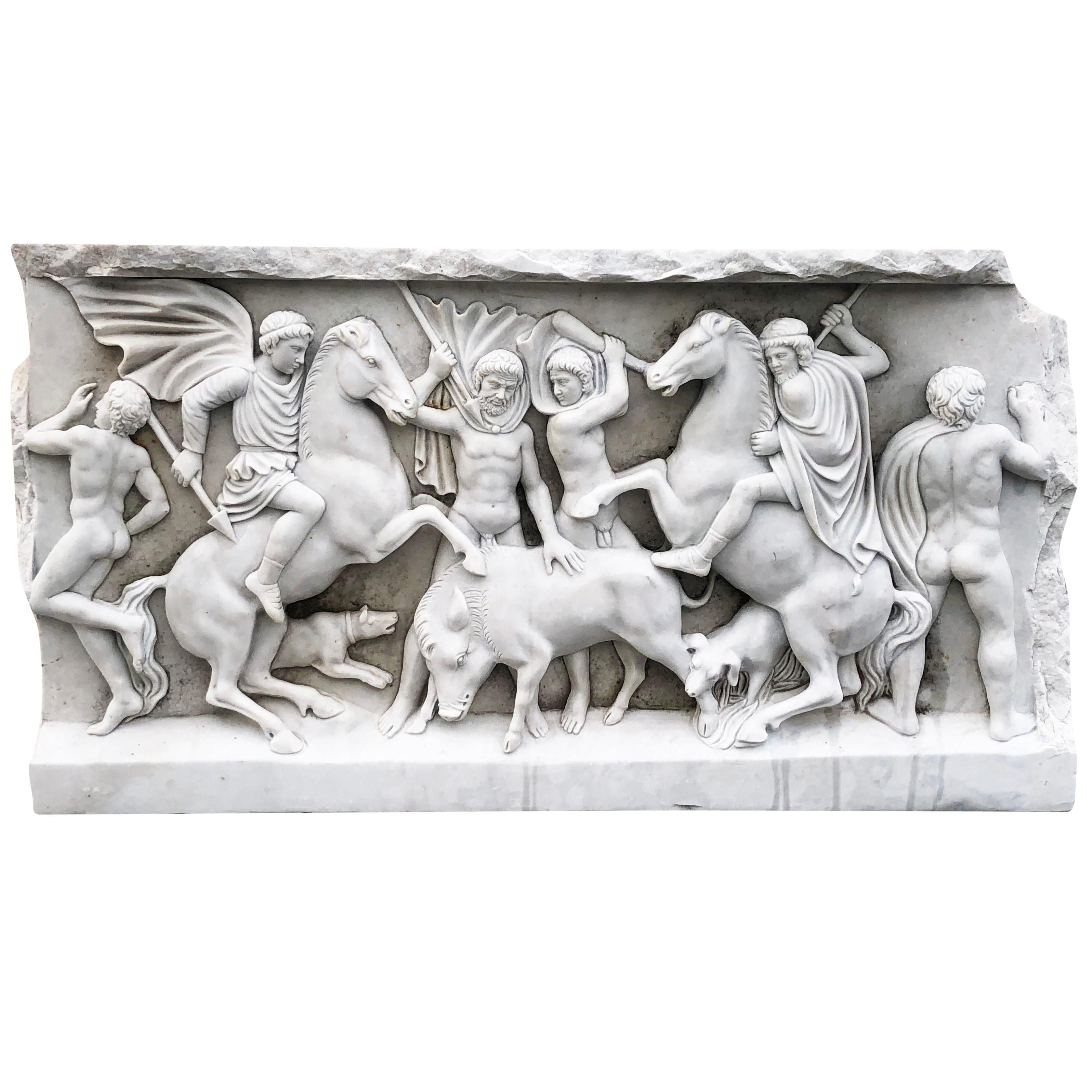 This Carrara marble bas relief sculpture was hand carved in England in the late 1800s, in good condition. The antique relief sculpture depicts the classical subject of Romans on horseback hunting a boar. This marble sculpture is suitable as both