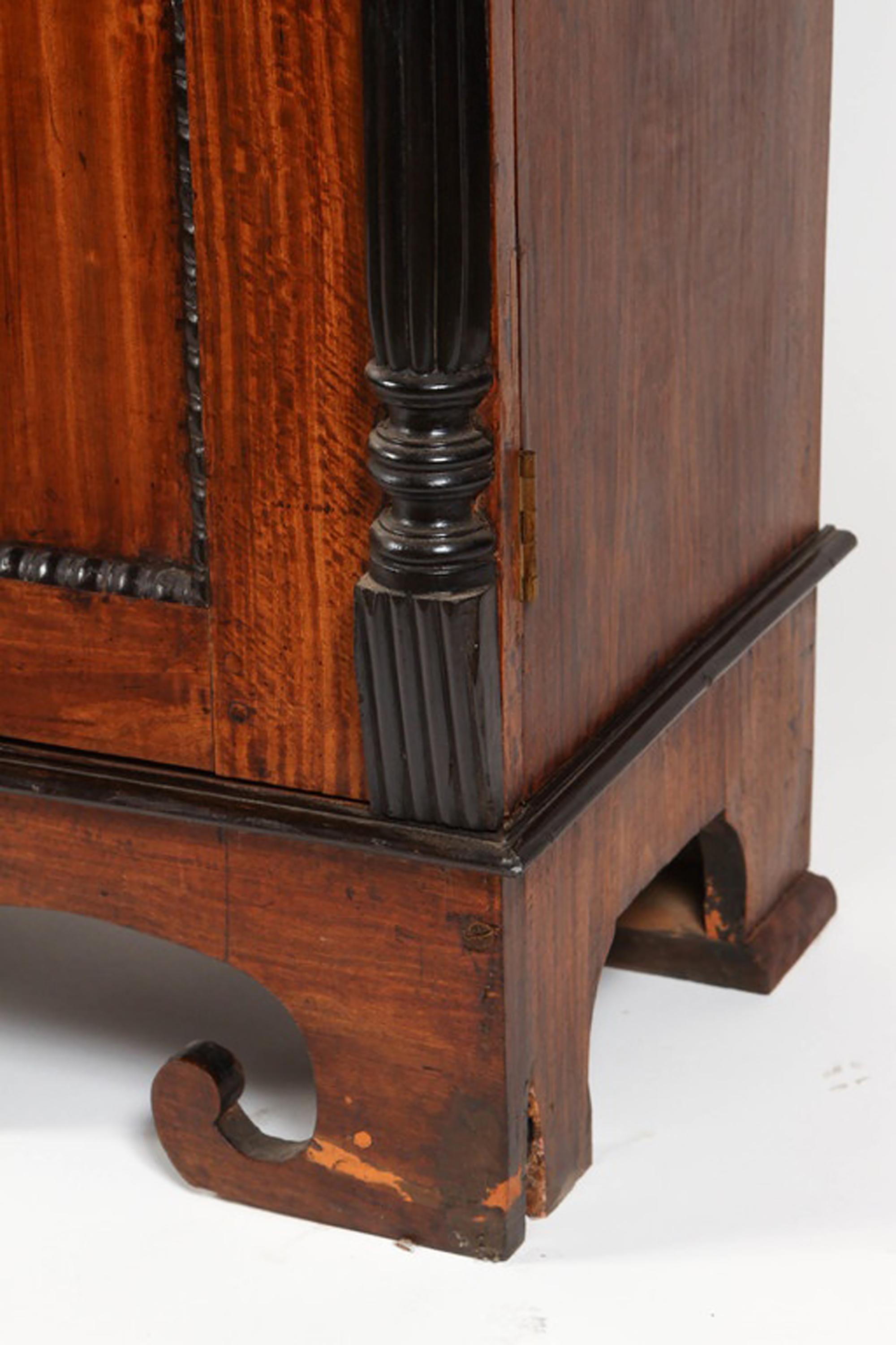 Early 19th century British Colonial cabinet of wide-paneled and figured solid satinwood with solid ebony trim. Sri Lanka, formerly known as Ceylon, is one of the few places in the word where satinwood and ebony are indigenous. It was prized by the