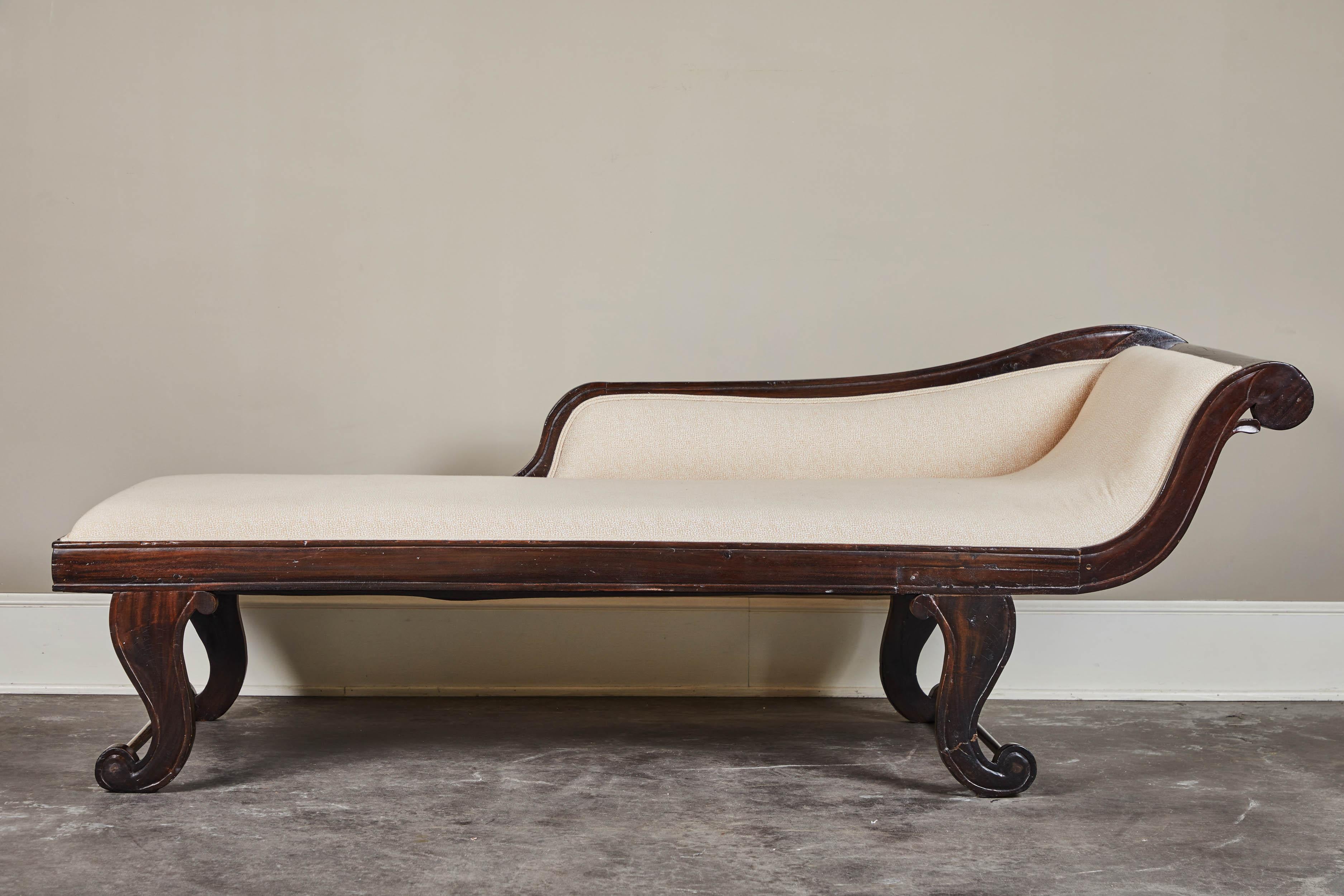A lovely 19th century British Colonial chaise comprised of Jakwood and new upholstery.