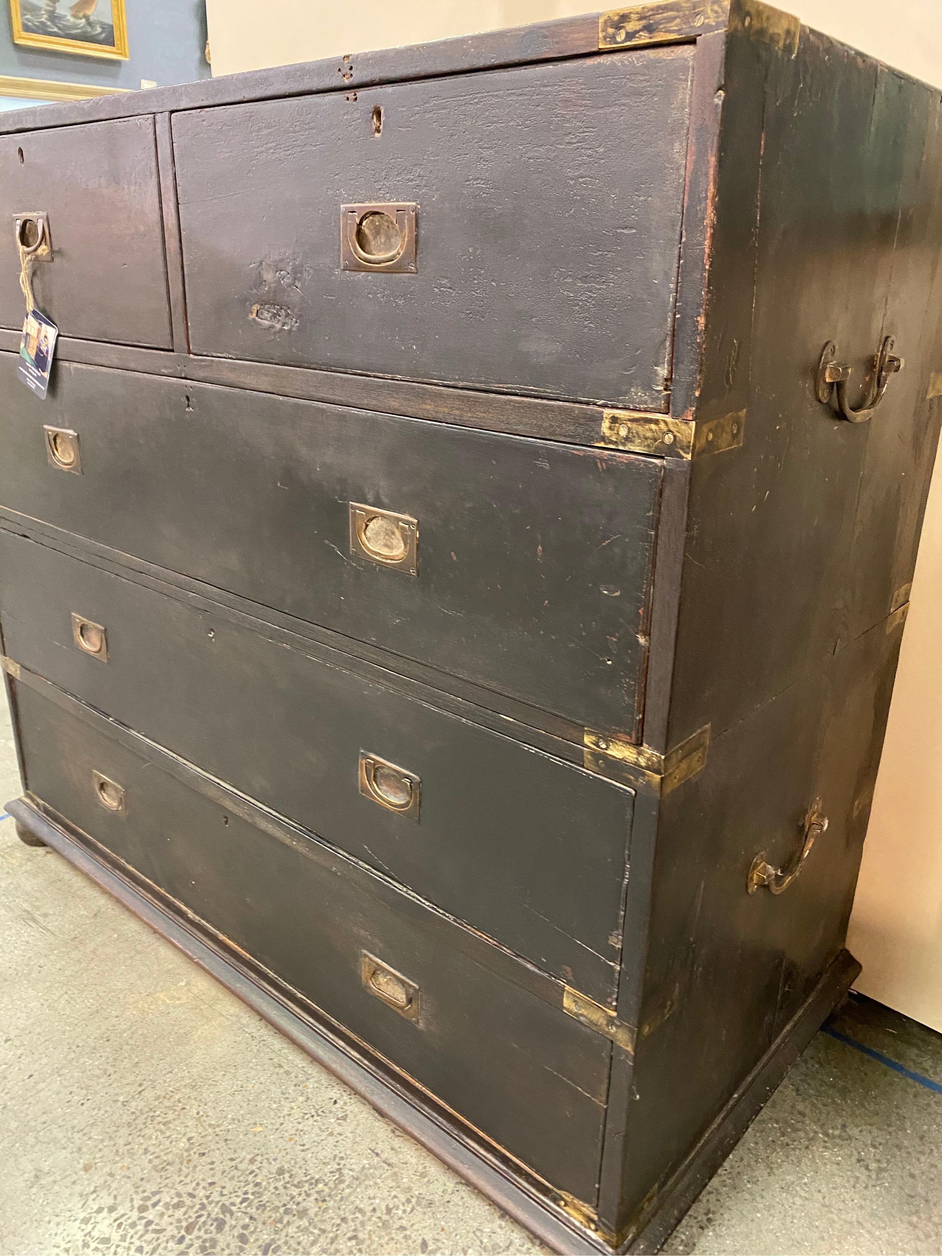 19th century British Colonial ebonized brass bound Campaign chest from the British East Indies. Original finish and patina with bits of the underlying mahogany exposed on the top from wear. This piece is in good shape with typical signs of wear and