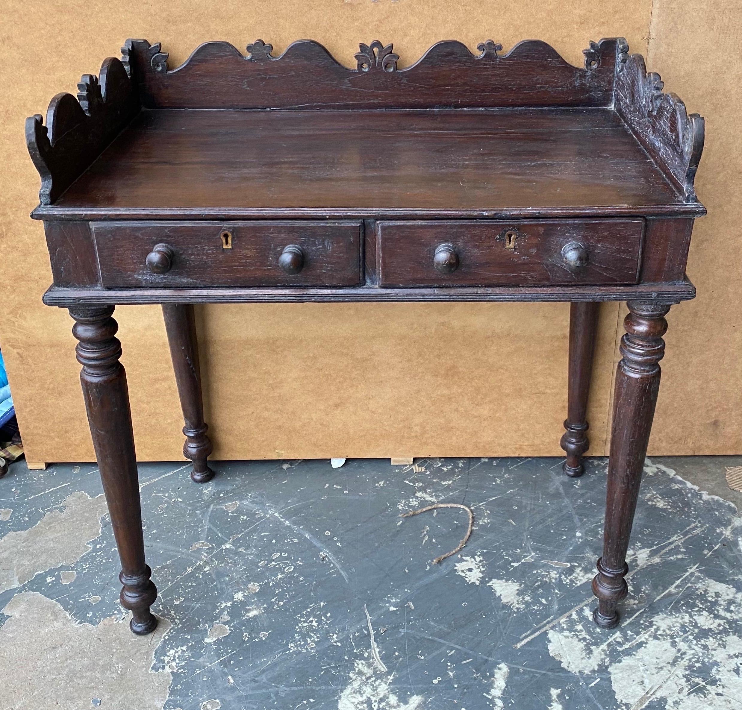 19th century British Colonial teak 2-drawer console from the East Indies.