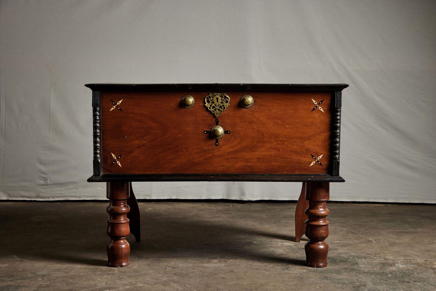 A handsome 19th century British Colonial trunk from Sri Lanka that features beautiful inlay detailing on the face and carved columns on the sides of the trunk. It also features beautiful brass hardware.
