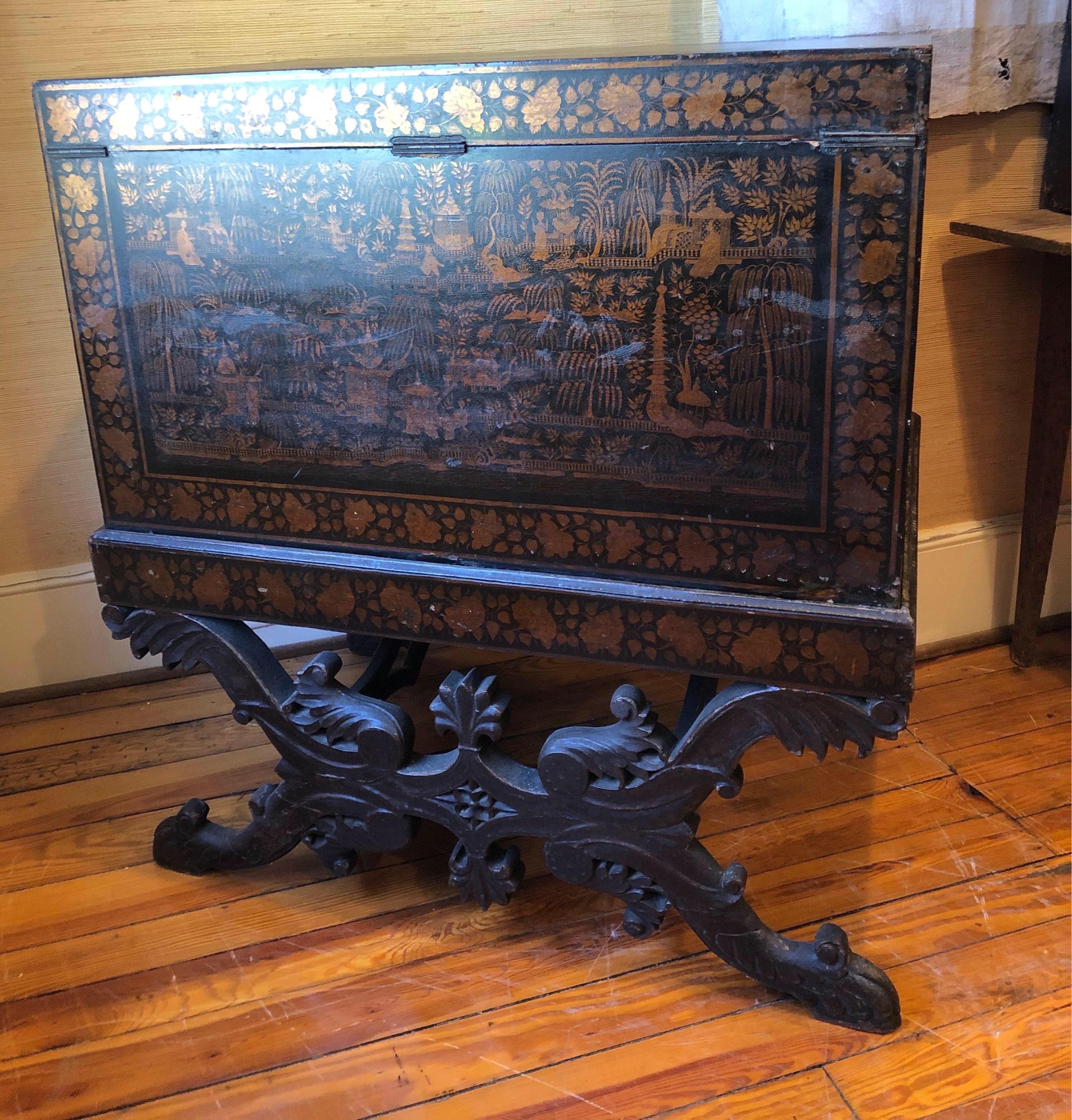 Very striking 19th century British lacquered chinoiserie chest on stand. The chinoiserie decoration is incredible and finished all around. The stand is carved and decorated. Interior of chest is in teal.