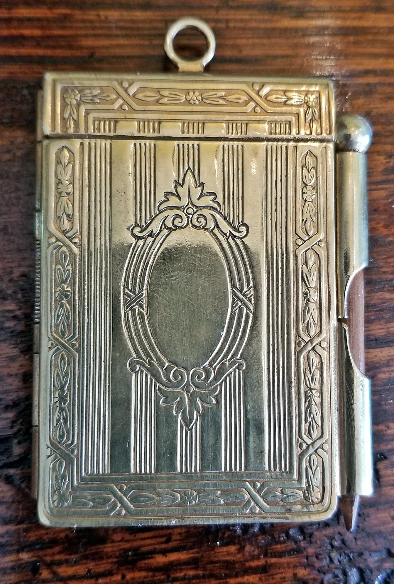 Pictures do not do a service to this cute little notepad/notebook from the late 19th century.

19th century British Ladies brass pocket notebook.

Made of brass…..complete with original pencil and notepad…….beautifully chased………beautifully