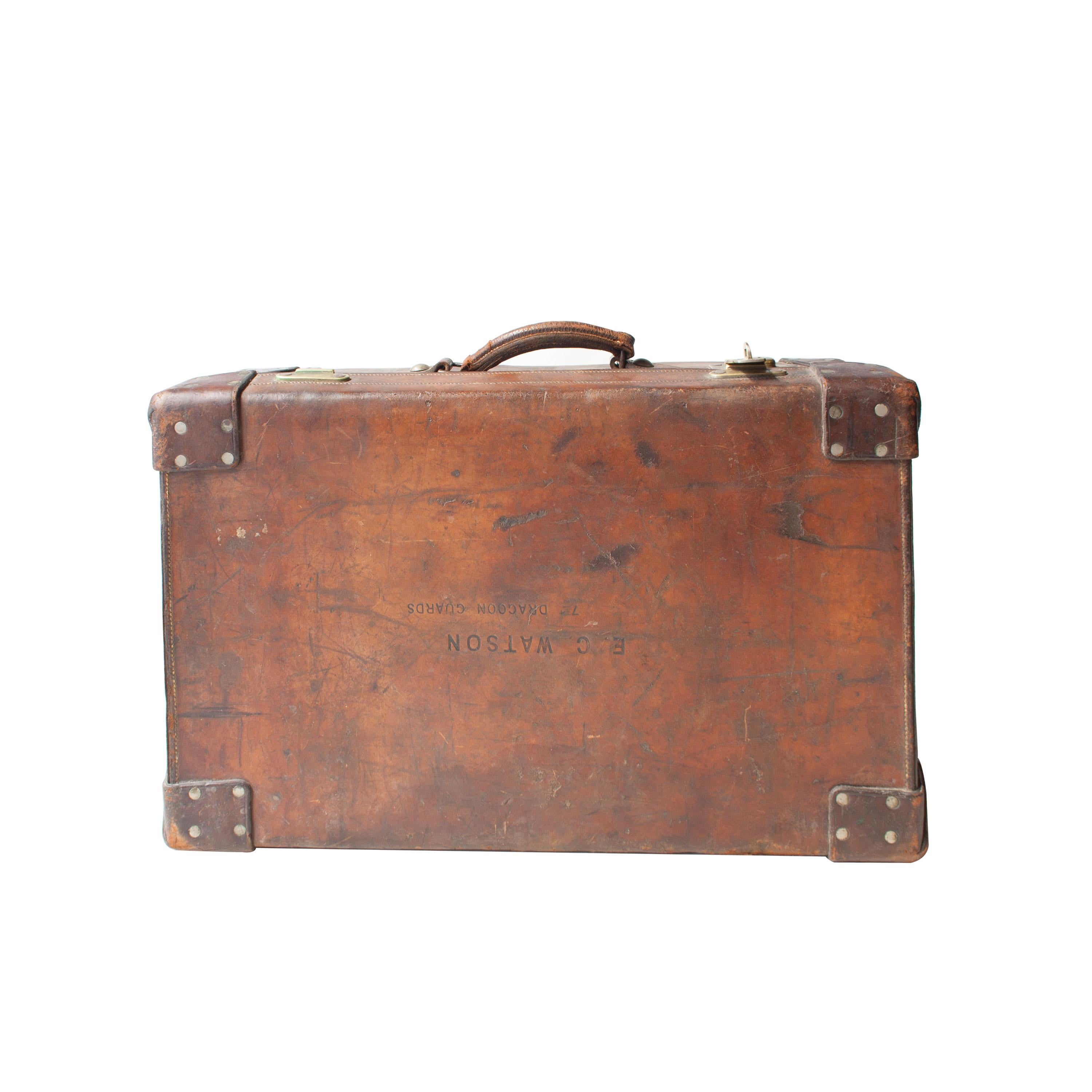 English suitcase belonging to the British Royal guard destined for India. Made of thick leather with bronze clasp and applications. Inscription on cover 