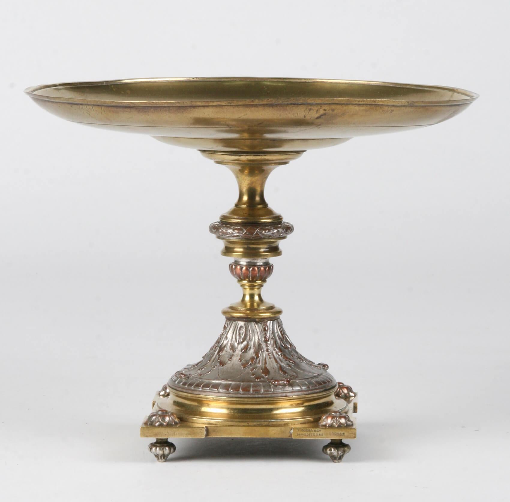 L. Oudry & Cie, gilt metal and bronze Tazza, with raised cupid, insect, floral, leaf and scroll decoration on turned stem with square base having further turned feet, 26.5 cm diameter, 21 cm high. It is signed by Leopold Oudry, famous bronze maker