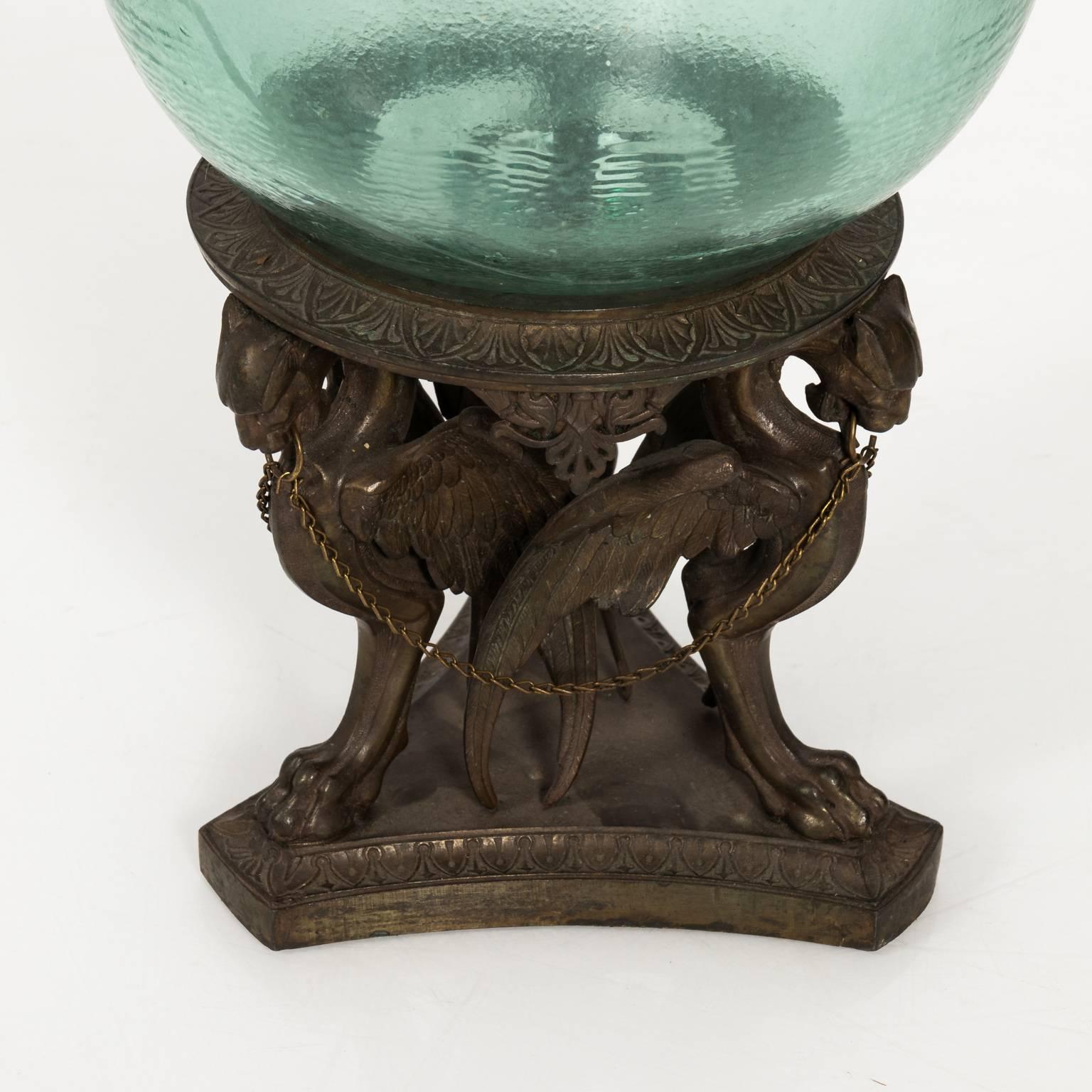 Glass bowl on a bronze stand decorated with winged griffins, circa 19th century.
 