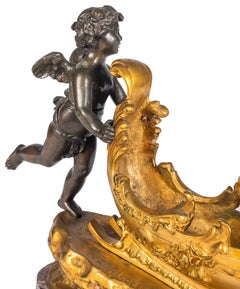 19th Century Bronze and ormolu cherub pushing a sleigh.