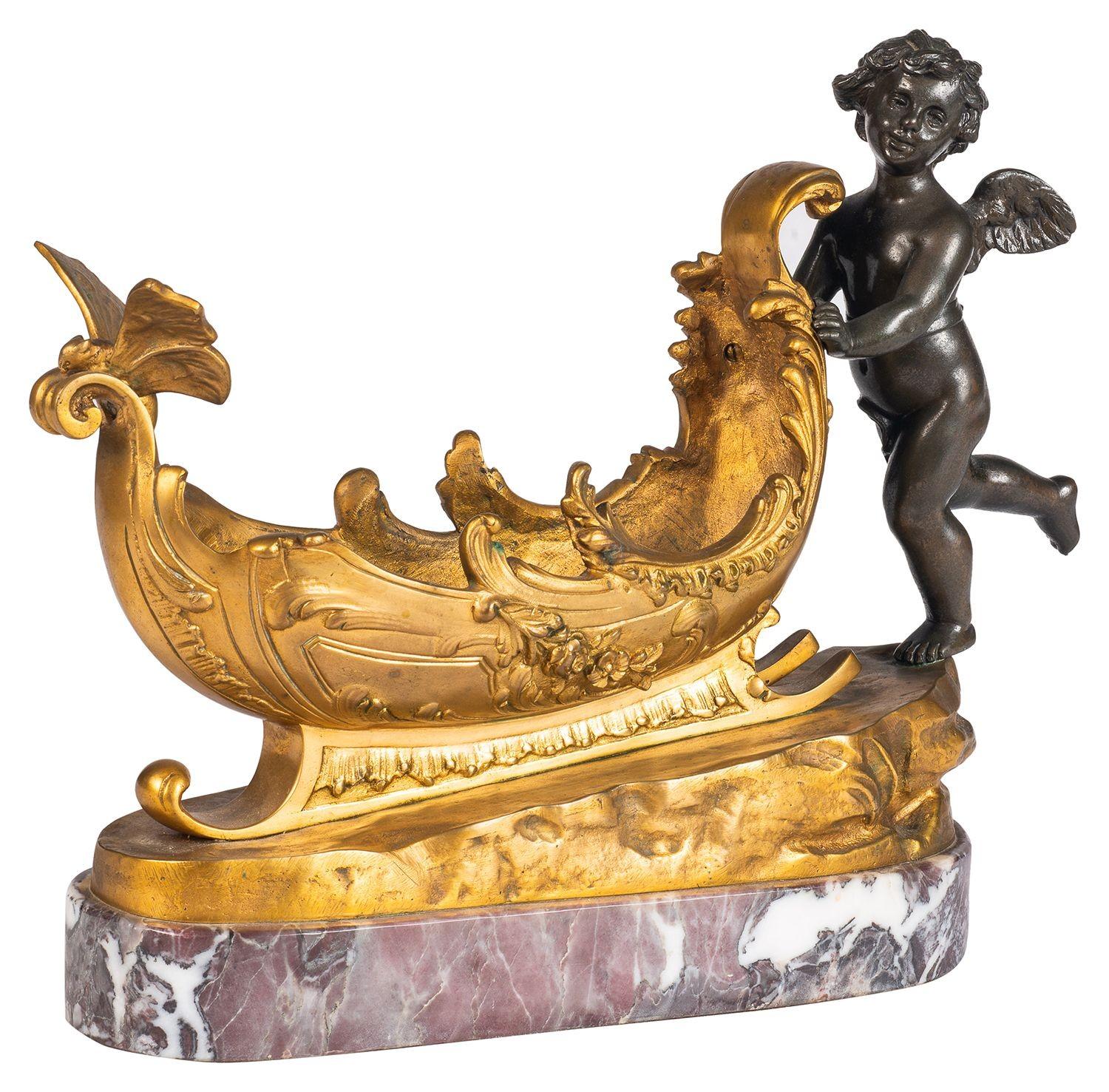 Romantic 19th Century Bronze and ormolu cherub pushing a sleigh. For Sale