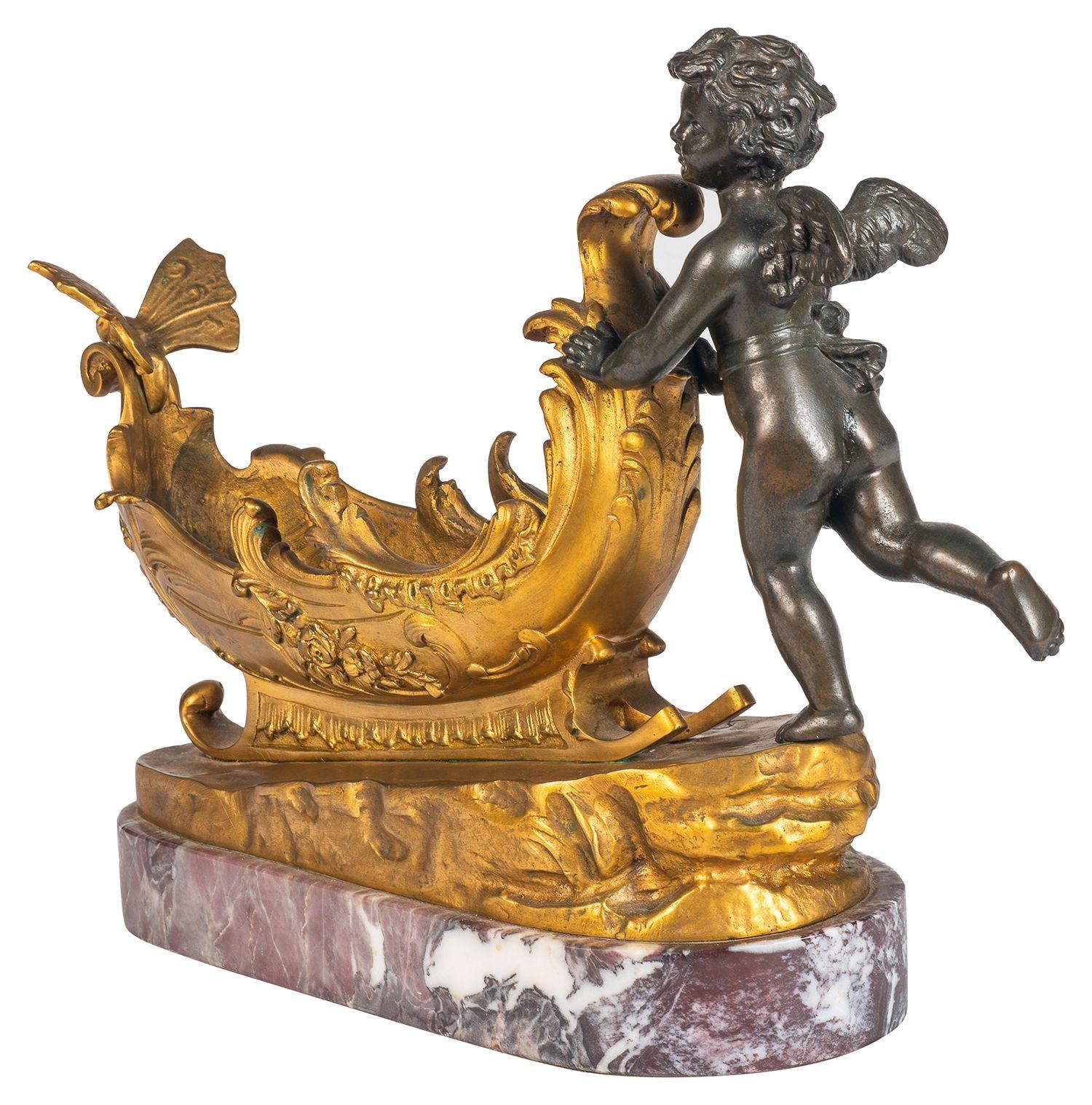 19th Century Bronze and ormolu cherub pushing a sleigh. In Good Condition For Sale In Brighton, Sussex