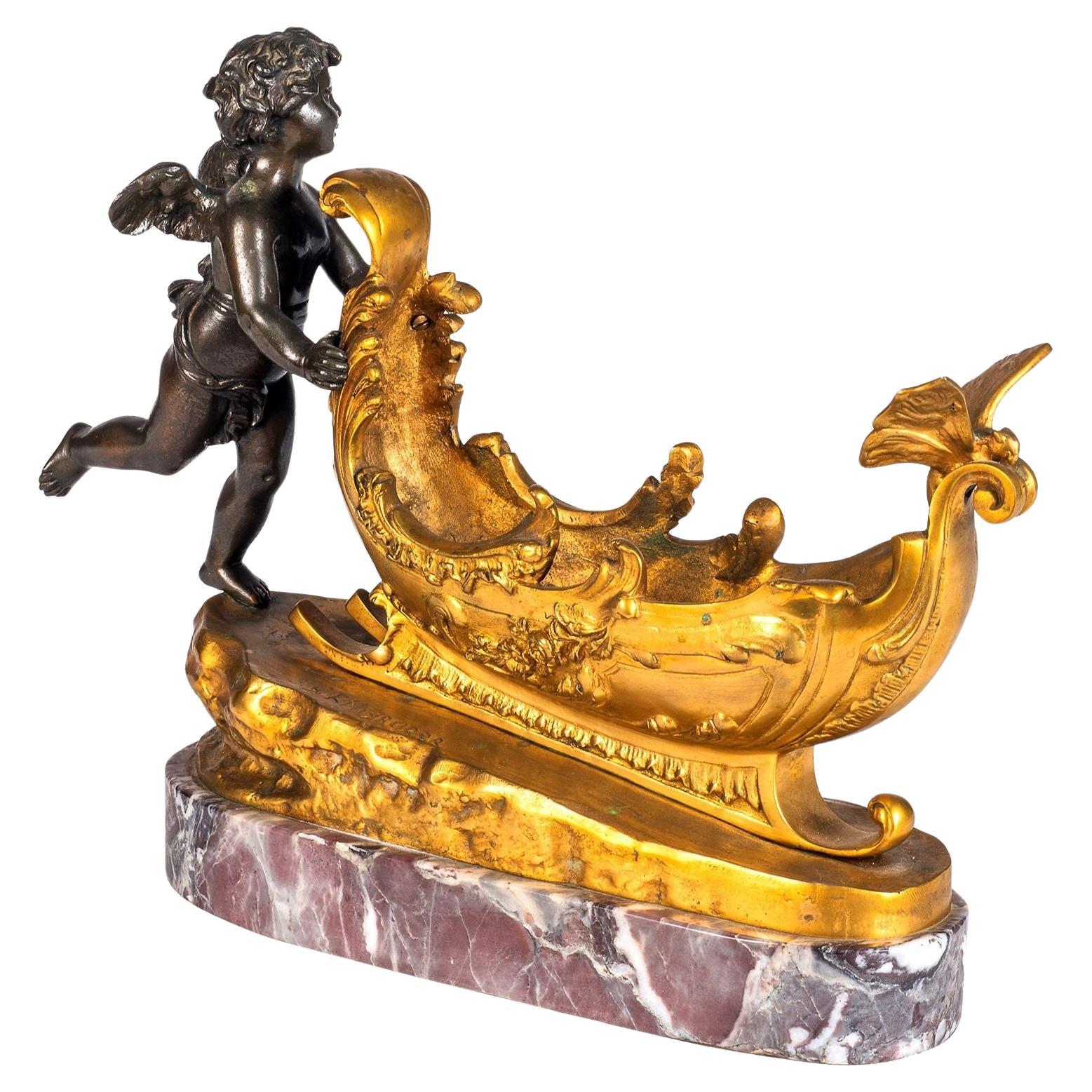 19e siècle Chérubin en bronze et bronze doré poussant un traîneau. en vente