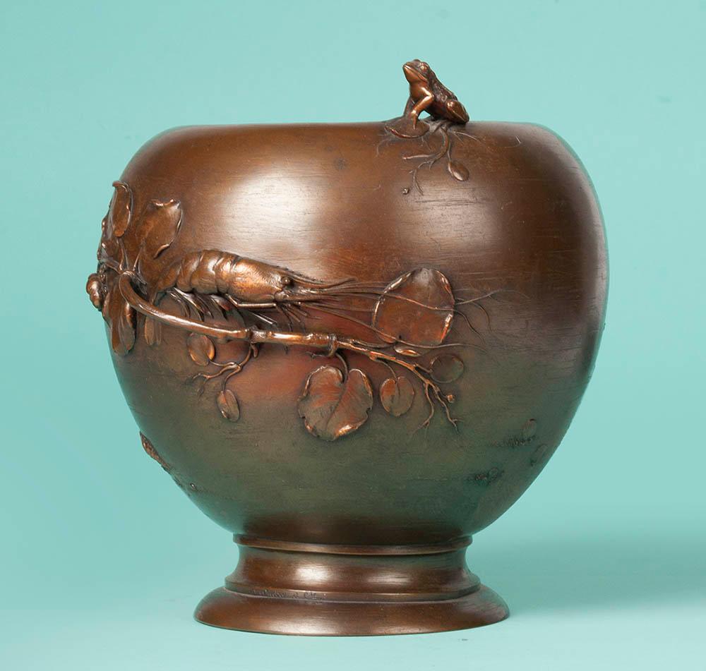 Very beautiful bronze flowerpot made by A. Oudry. The design is typically French Art Nouveau style with influences from Japanese art. With all images of elements from nature, such as mussels, a frog, water lilies, shells, shrimps and flowers.
This