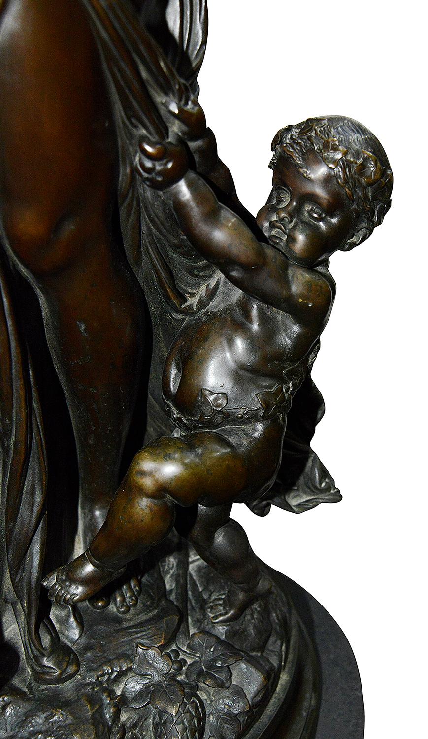 A very impressive and good quality 19th century bronze study in the style of Carrier-Belleuse depicting a pair of classical Bacchus influenced dancing maidens holding a tambourine and bunches of grapes, a putti to their side. Raised on a rouge
