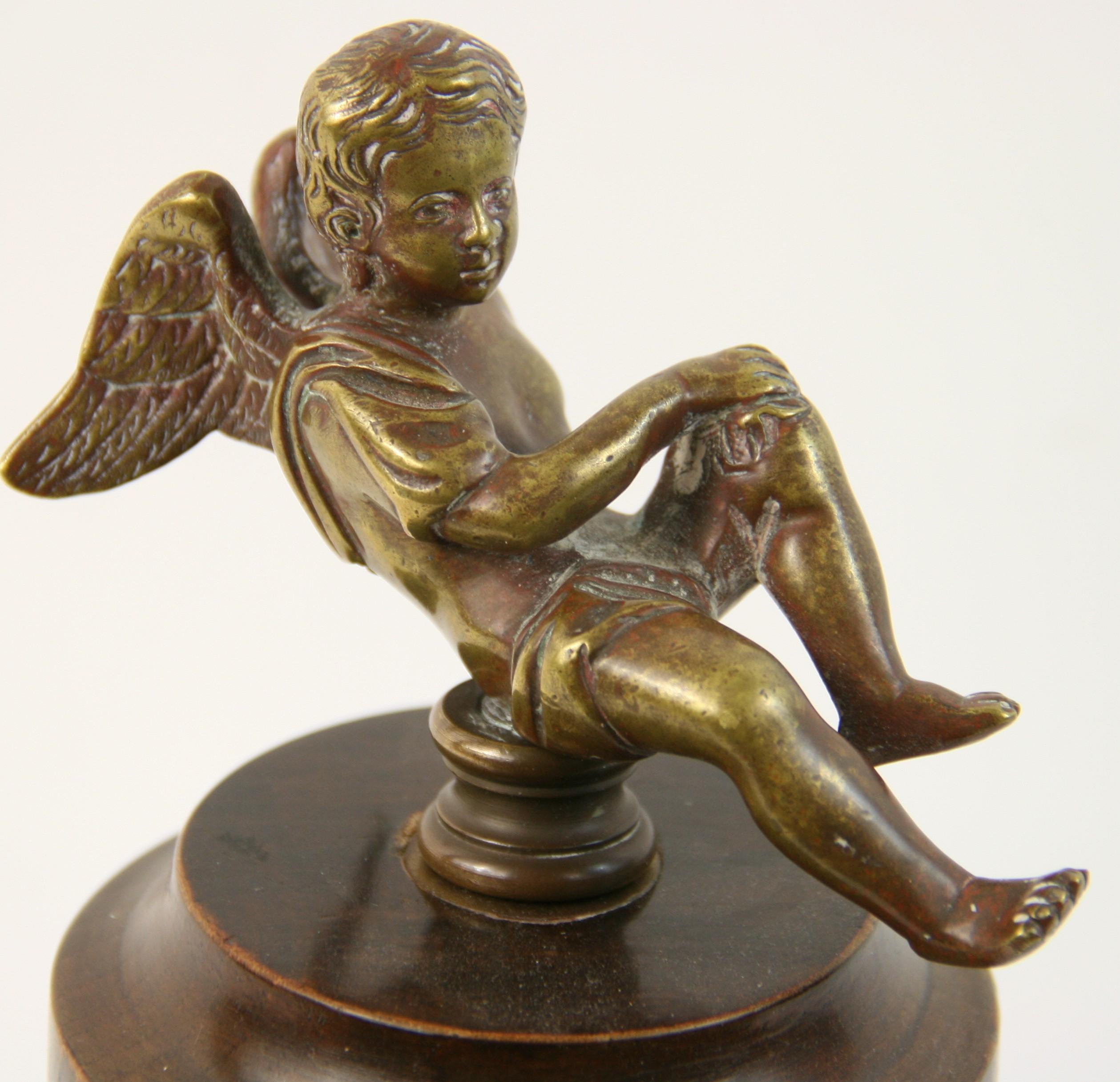 8-164 bronze cherub sculpture set atop a mahogany wood base.