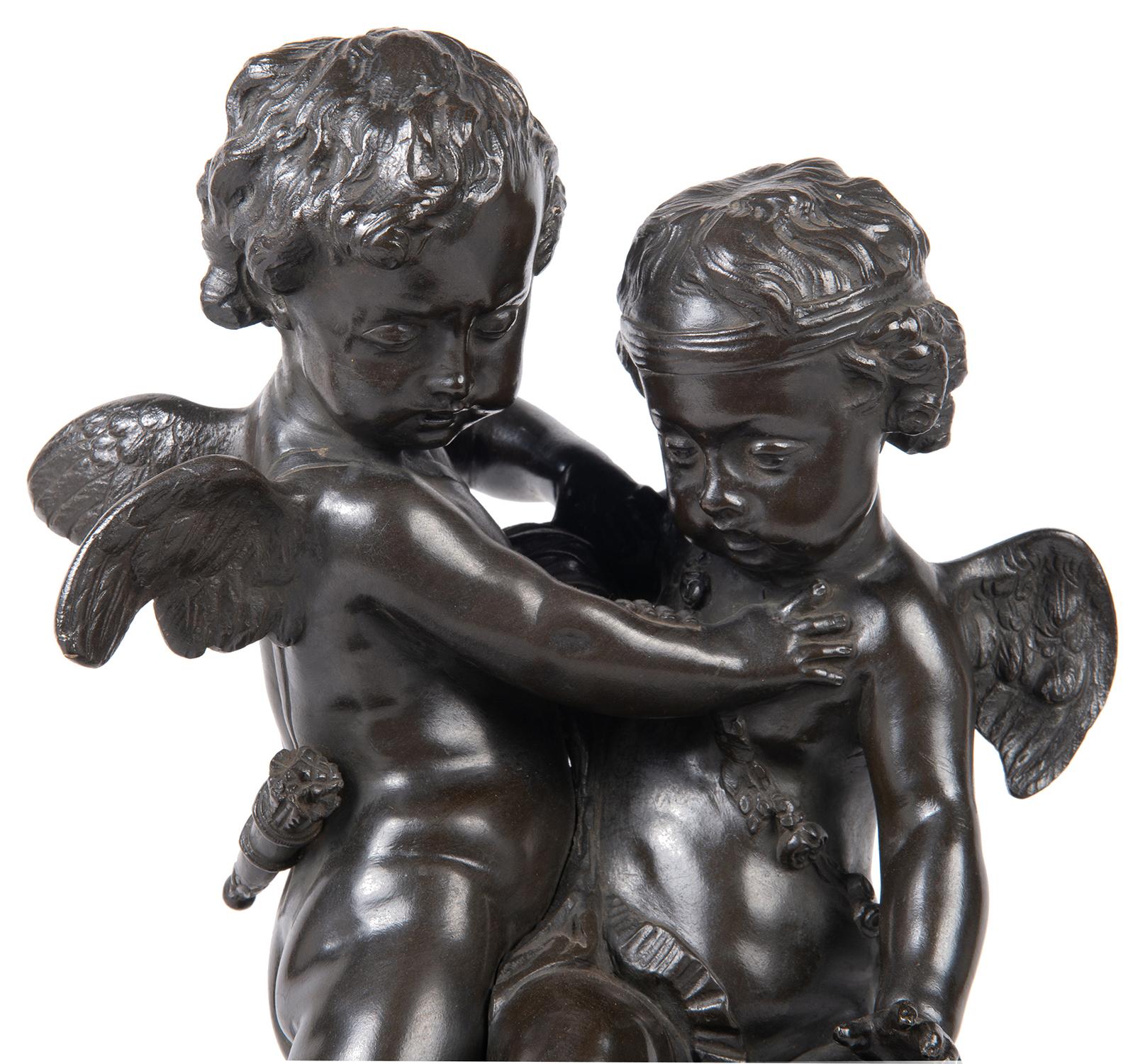 An enchanting and classical late 19th century patinated bronze study of two cherubs wrestling over a heart, after Etienne-Maurice Falconet (1716-1791).