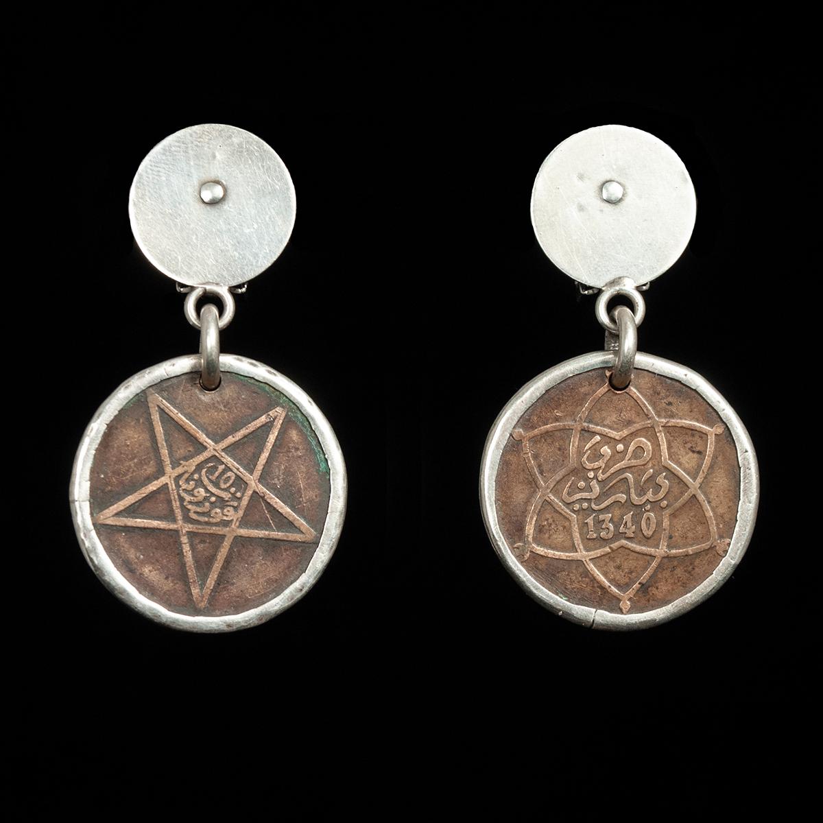 19th Century Bronze Coin with Silver Bezel Earrings by Jewels of Santa Fe/Marrakesh

A pair of earrings made by Jewels with bronze coins from Morocco and Egypt set in silver bezels and hung from her signature hand made disks.

They are 2.25 inches