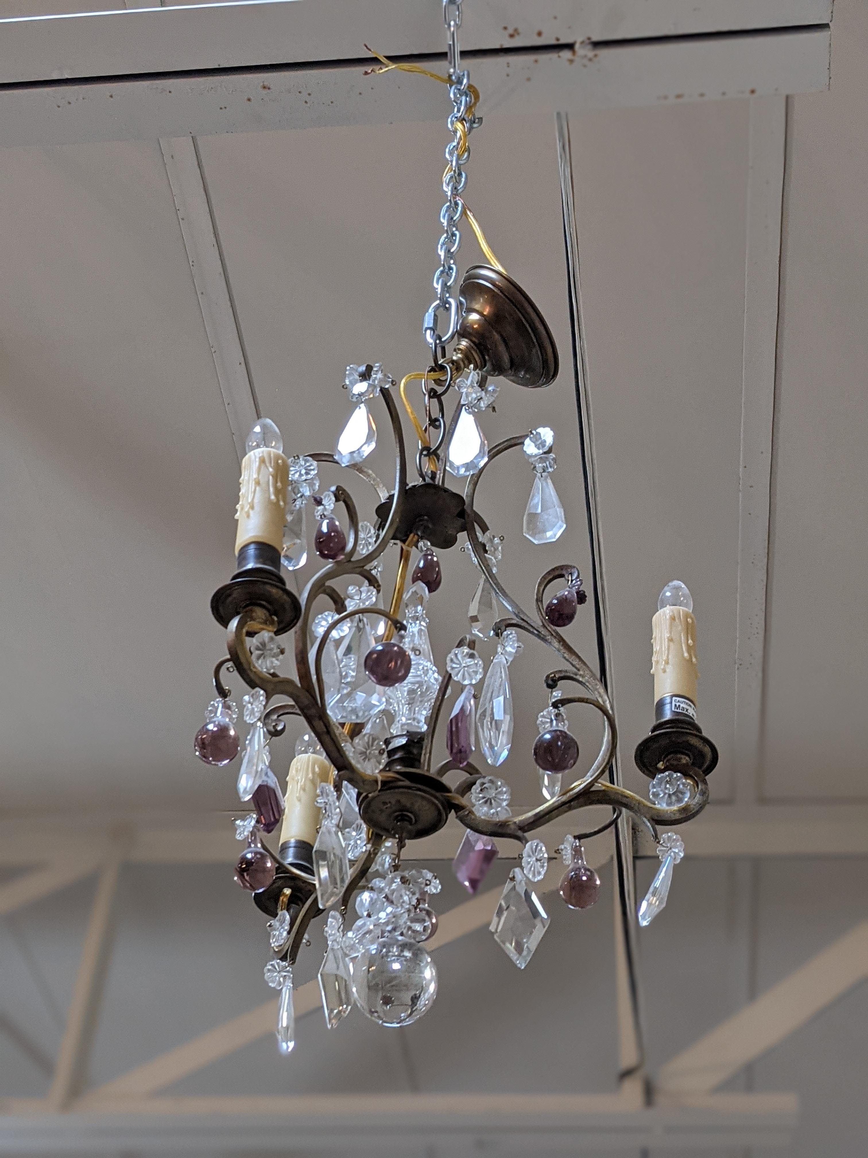 This bronze and crystal chandelier with 3 lights origins from France.

19th century period.