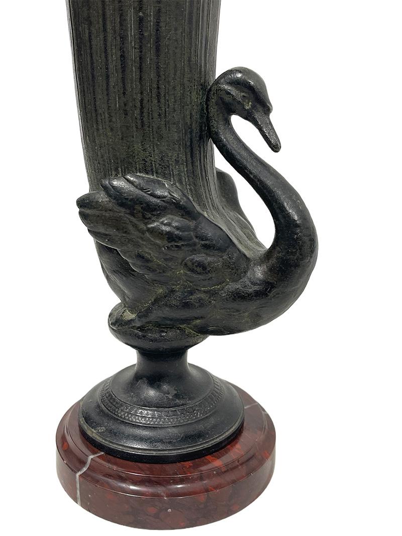 19th century bronze decorative rhyton style shaped swan vases.

Bronze rhyton style decorative shaped vases with swan on round red/brown marble base. The set in a trumpet shaped with straight lines and a border with scene of walking swan. Very