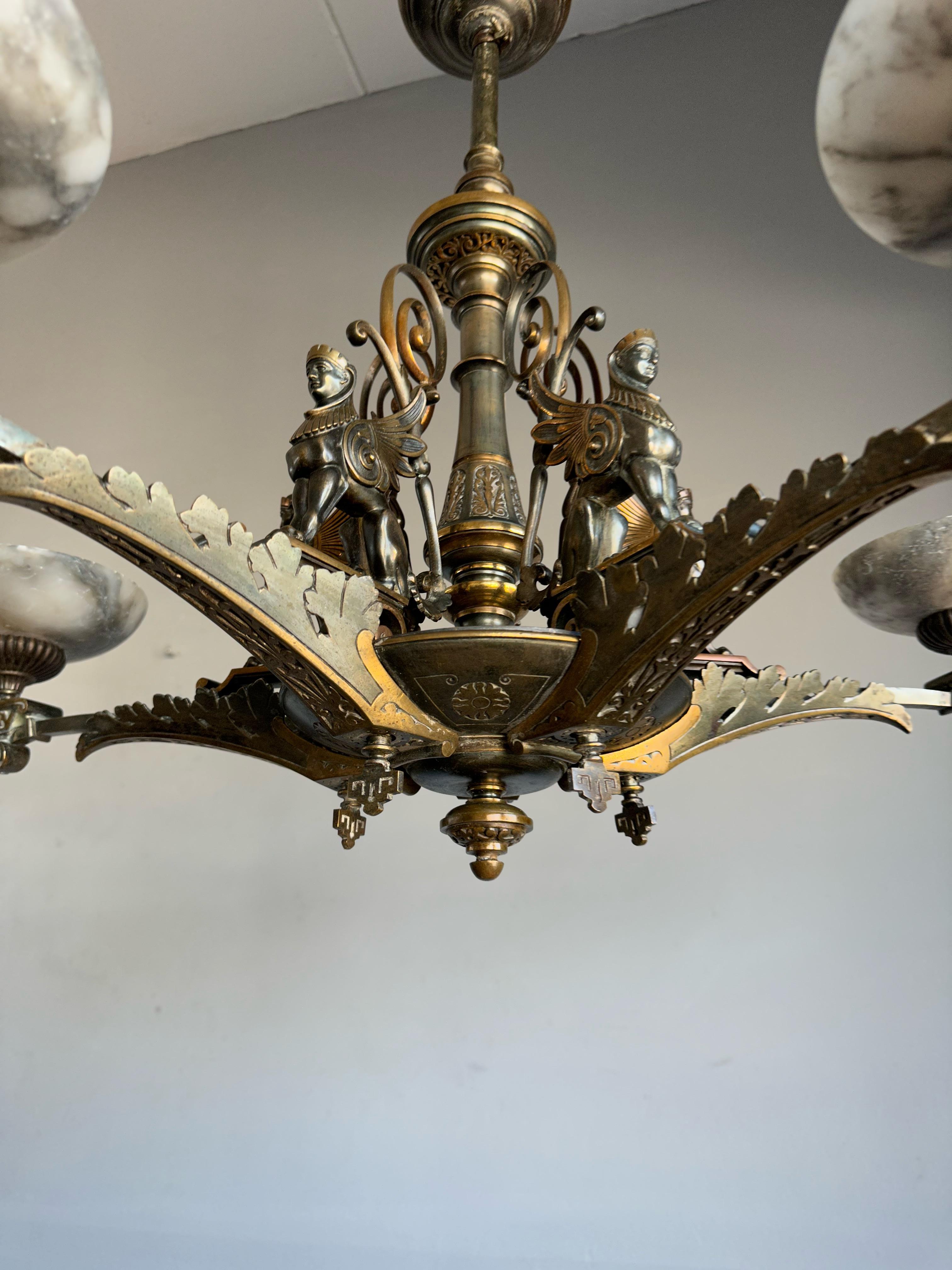 Antique rewired electrified (was original gas) 5-light pendant with sitting Sphinx sculptures.

The first owner of this top of the line, sculptural chandelier would have been very wealthy. This finest of Egyptian Revival examples of 19th century