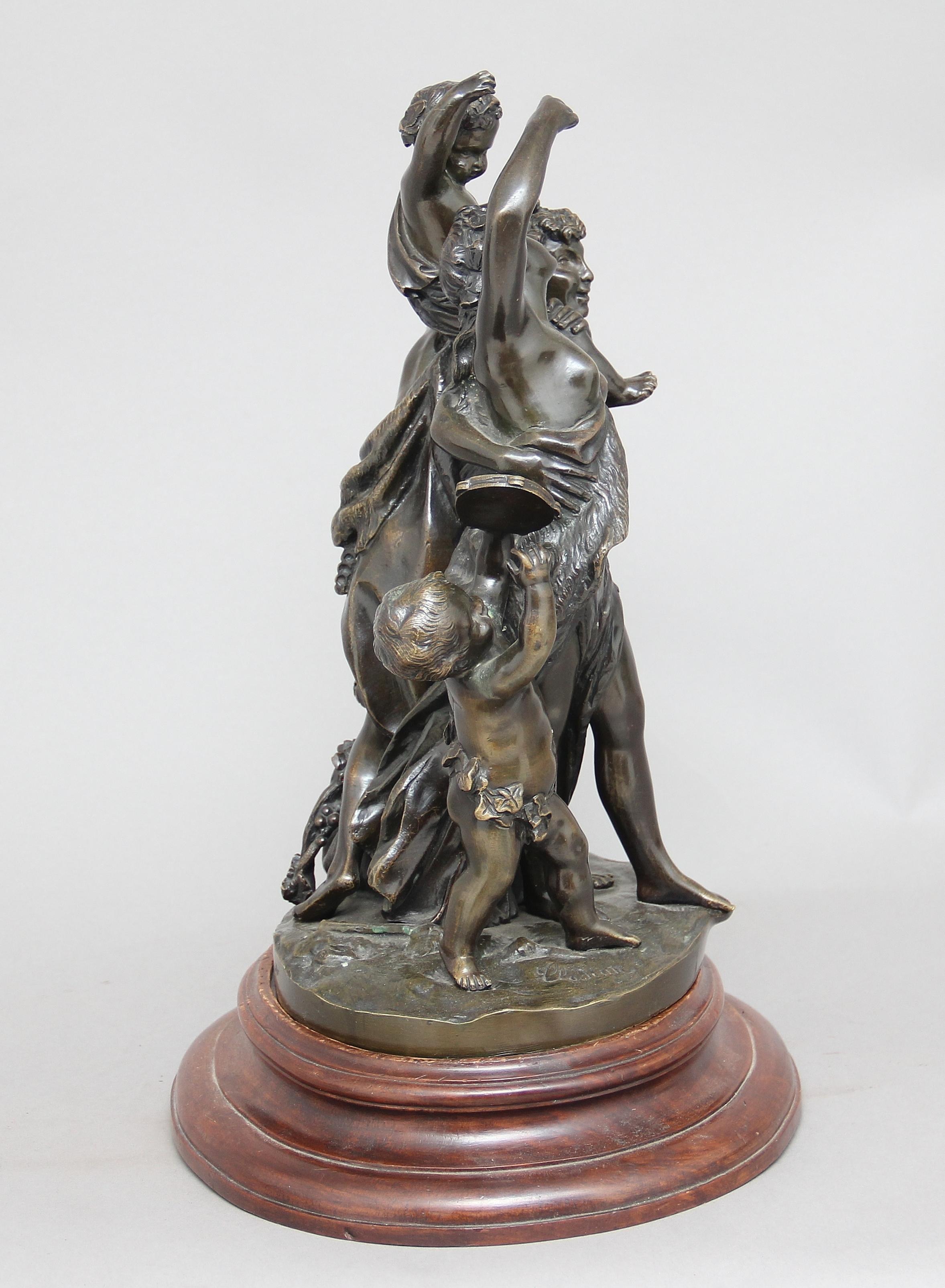 A 19th century French bronze figural group of a man, woman and two children standing on a wooden moulded circular plinth, lovely quality and patina. Signed Clodion, circa 1880.
 