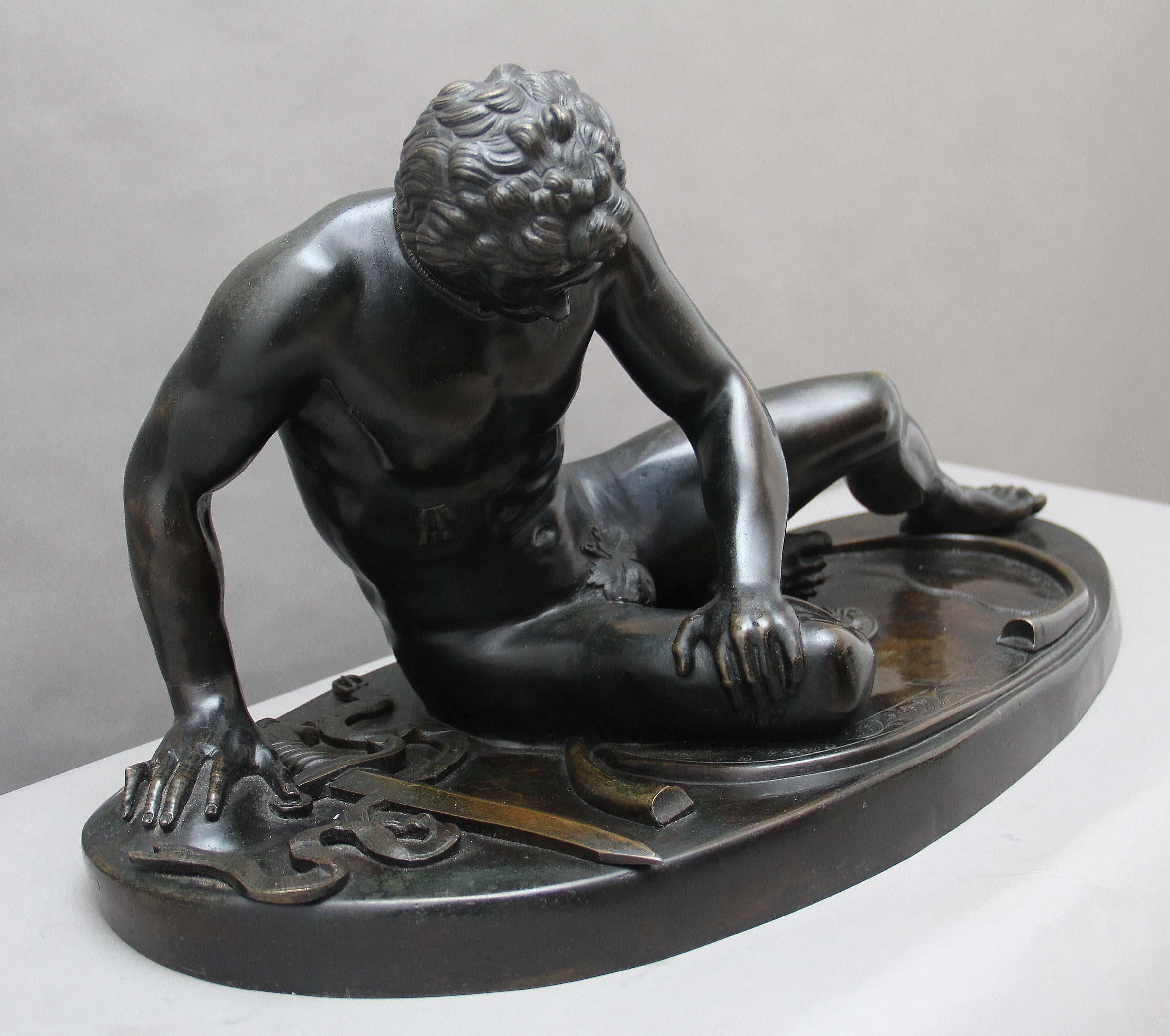 A superb quality 19th century French bronze figure of “The Dying Gaul” (The Dying Gladiator) supported on an oval bronze base, circa 1870.
 
The Dying Gaul or The Dying Gladiator, is an ancient Roman marble copy of a lost Hellenistic sculpture,