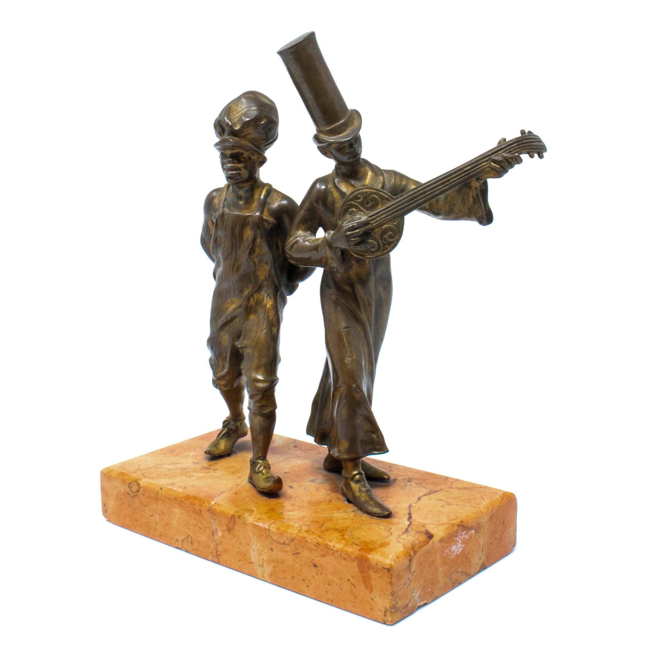 19th century bronze figure of two street boys, one with tall hat and a banjo, on a marble base.