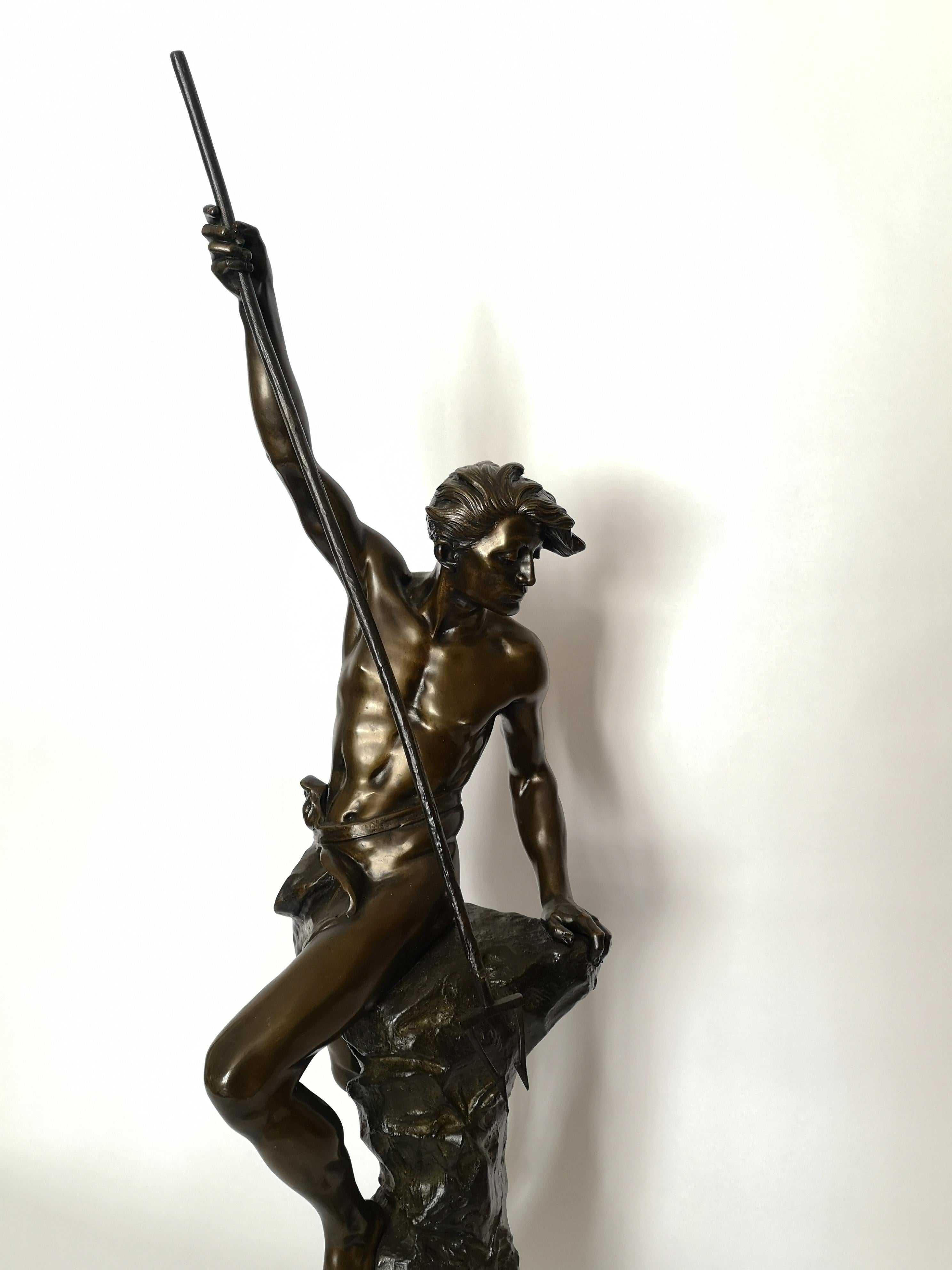 A late 19th century bronze of a fisherman with a harpoon, he is sitting on a rock with waves crashing at the base.
Ernest Justin Ferrand was a French artist who was active in the 19th century and the first half of the 20th century. He regularly