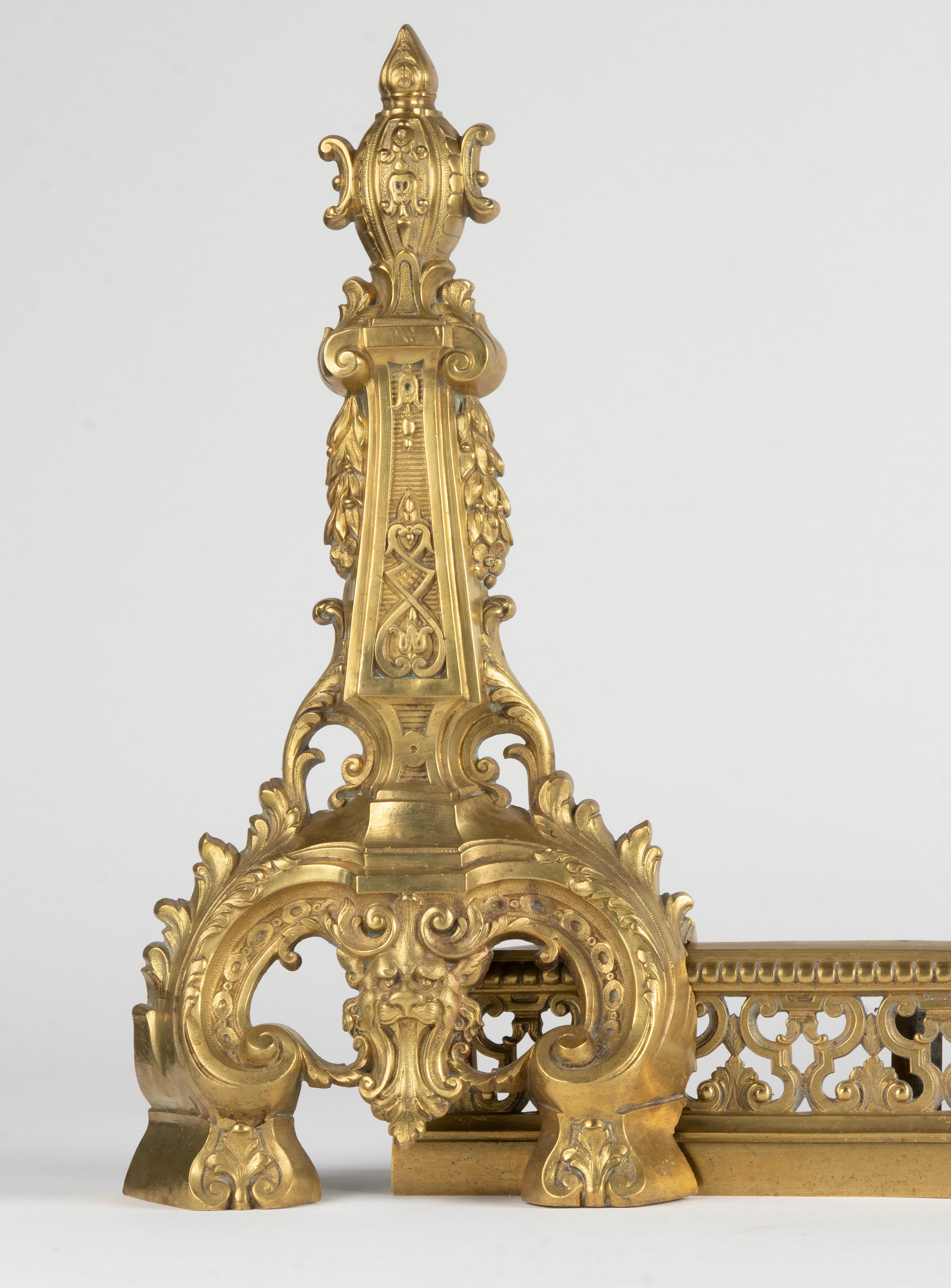 Beautiful set of fireplace andirons, dating from the end of the 19th century. They are made of bronze, cold gilded, in Renaissance style with lavish decorations. The size is adjustable because this set consists of three separate parts. The two side