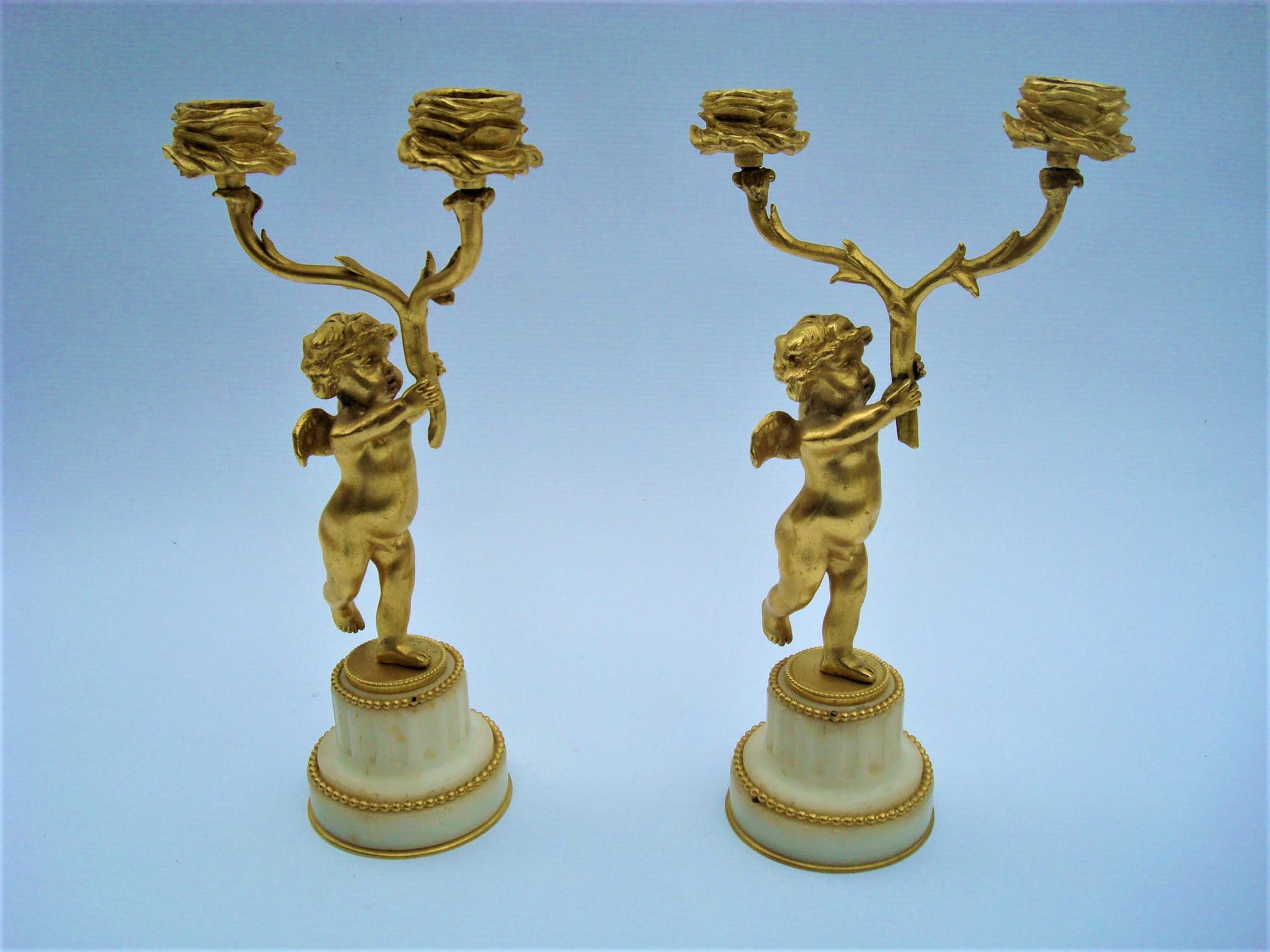 Pair of 19th century bronze gold-plated two-arm cherub figural candelabras. F. Linke
Gilt bronze cherubs with two arm candelabras, mounted on white marble pedestal, circled by gilt bronze gallery. Both Signed F. Linke.