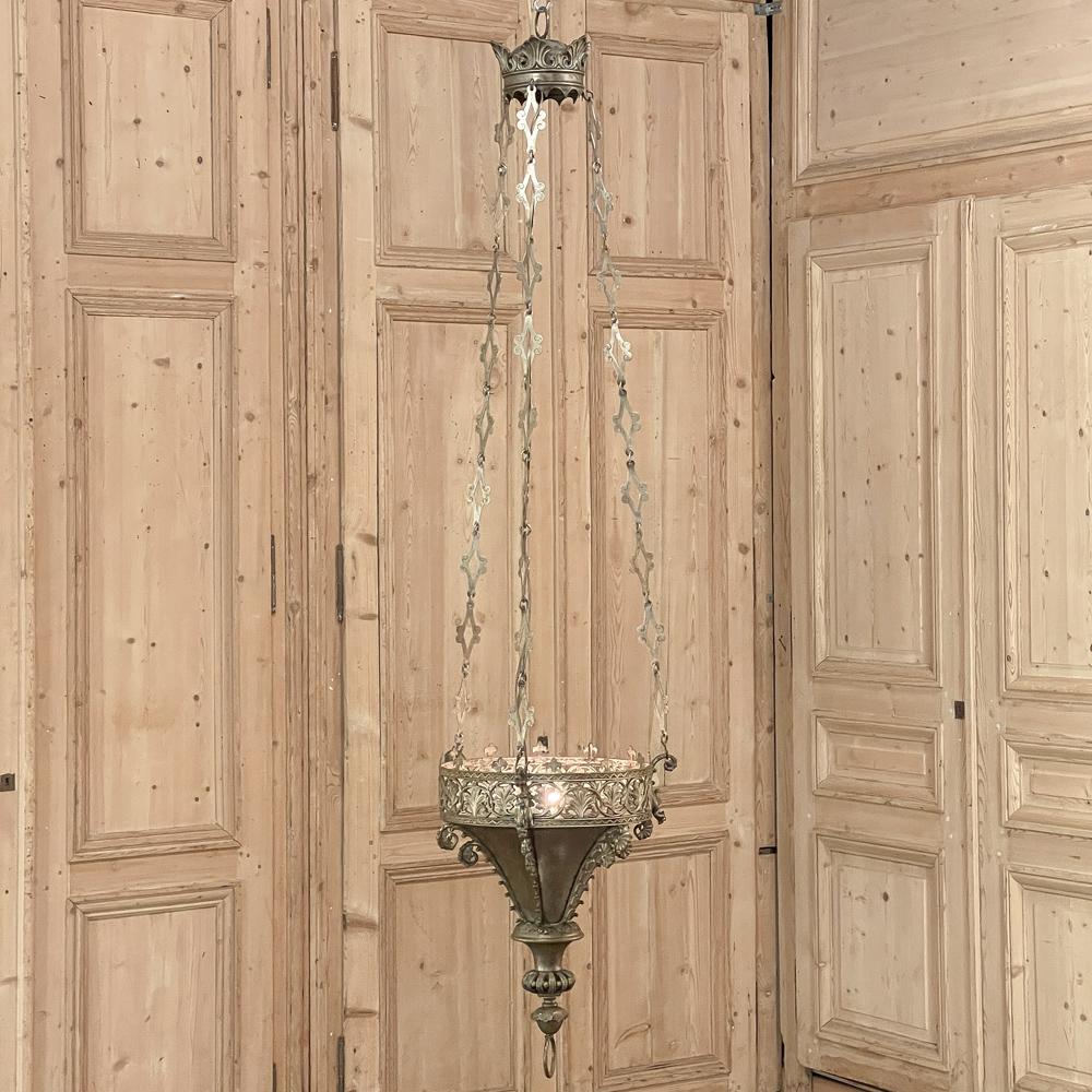 19th Century Solid Bronze Gothic Chandelier was crafted in bronze with a lustrous natural finish, and was originally designed for church use with candles or incense. The Gothic Revival style was first made popular in England throughout the Regency