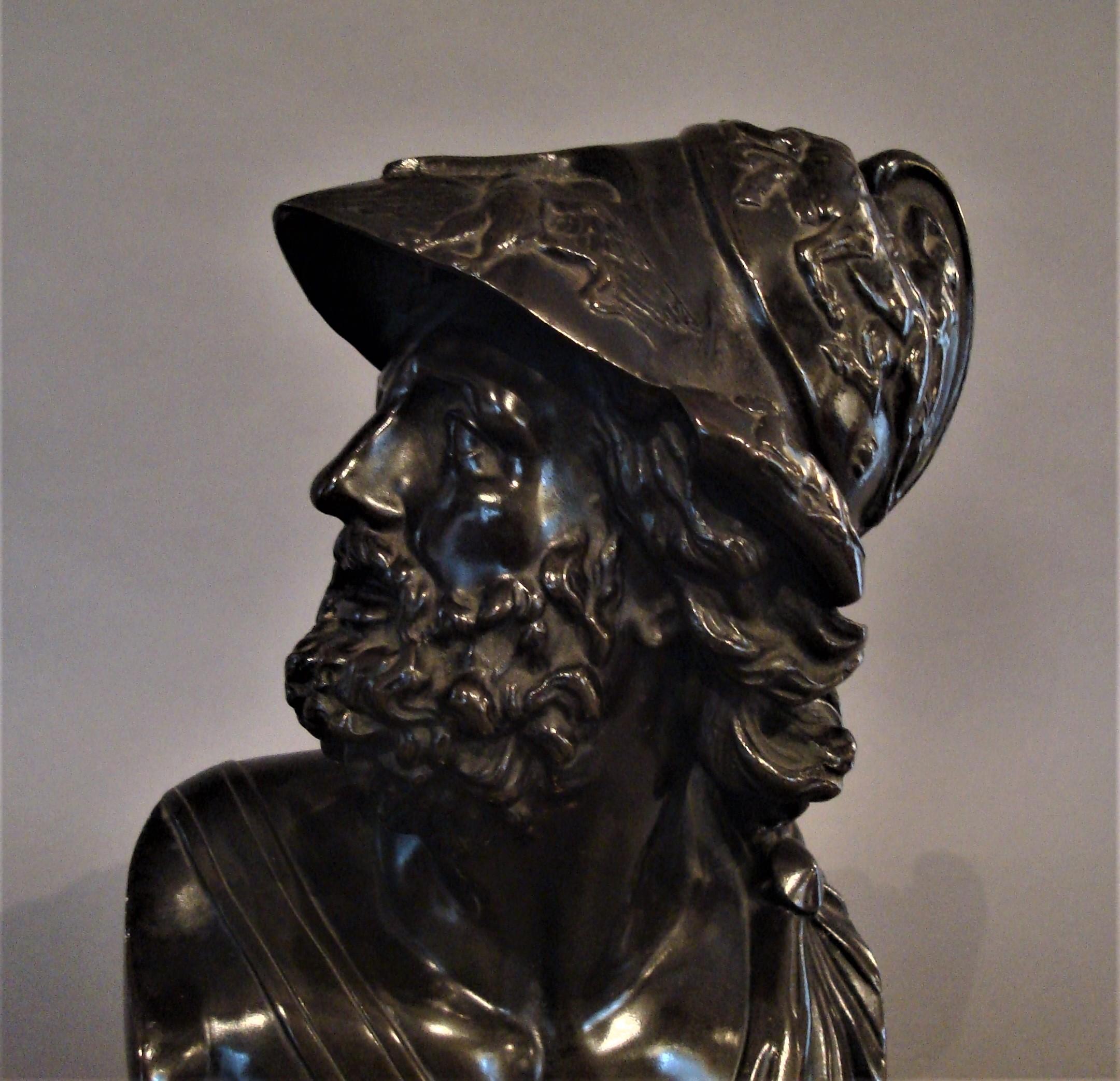 19th century bronze Grand Tour bust of Ajax; depicting the Greek hero looking dexter, bearded and with flowing hair, his helmet cast with centaurs fighting soldiers, and crouching panthers below, the peak with a pair of eagles. His chest with a sash