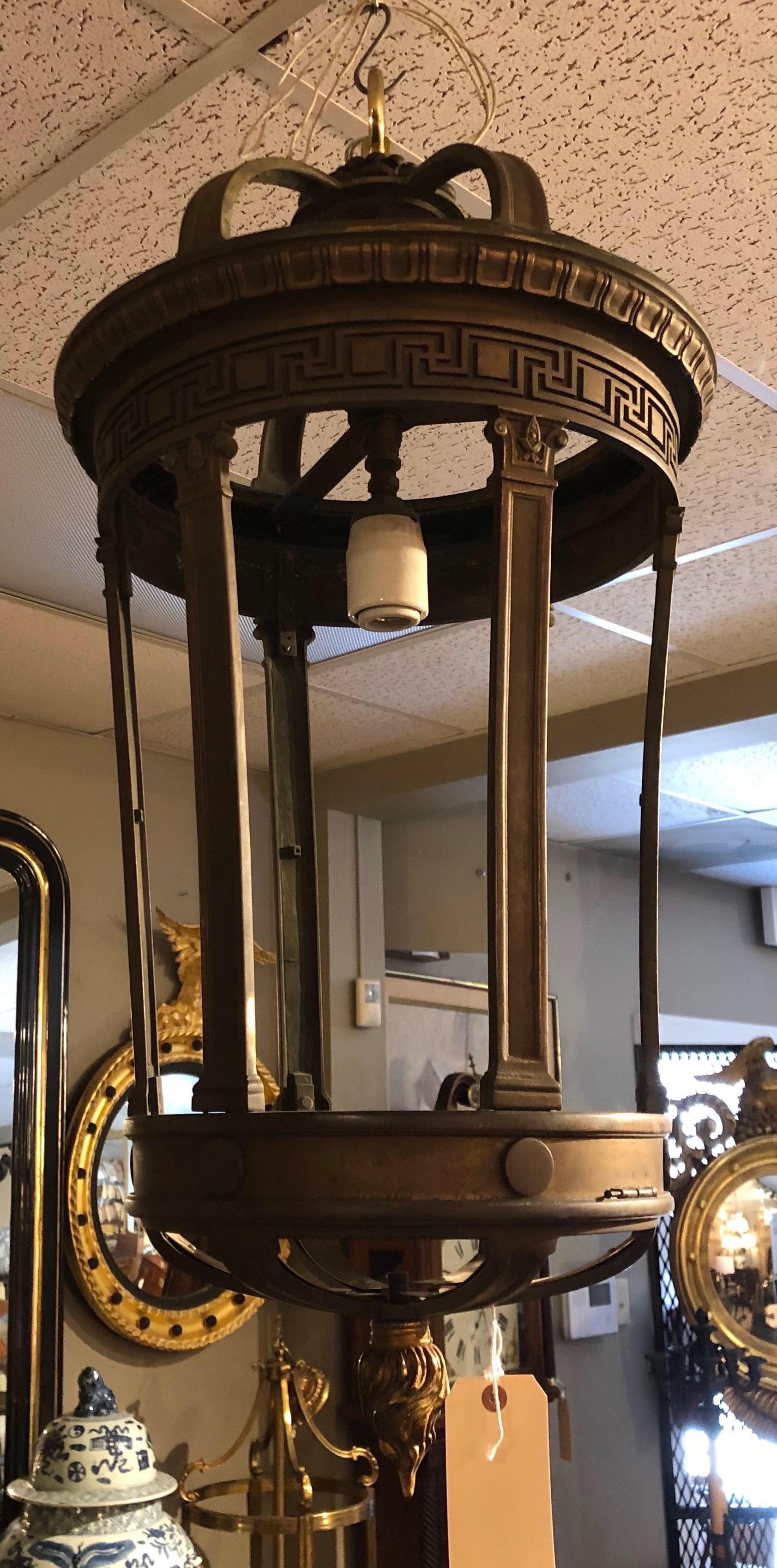 Incredible quality 19th century bronze neoclassical style hall lantern with Greek key motif border and bottom finial of a flame.