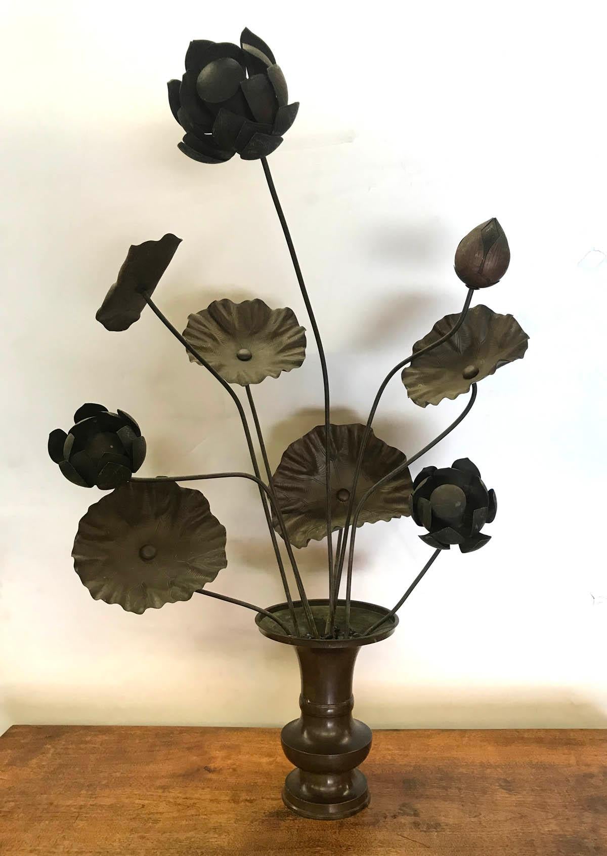 Nine hand sculpted bronze lotus flowers in one of two bronze vases. These originally sat in a temple in Kyoto. Dark original patina, beautiful detail on flowers and petals. Graceful and elegant. Can arranged freely within the vase, or removed from