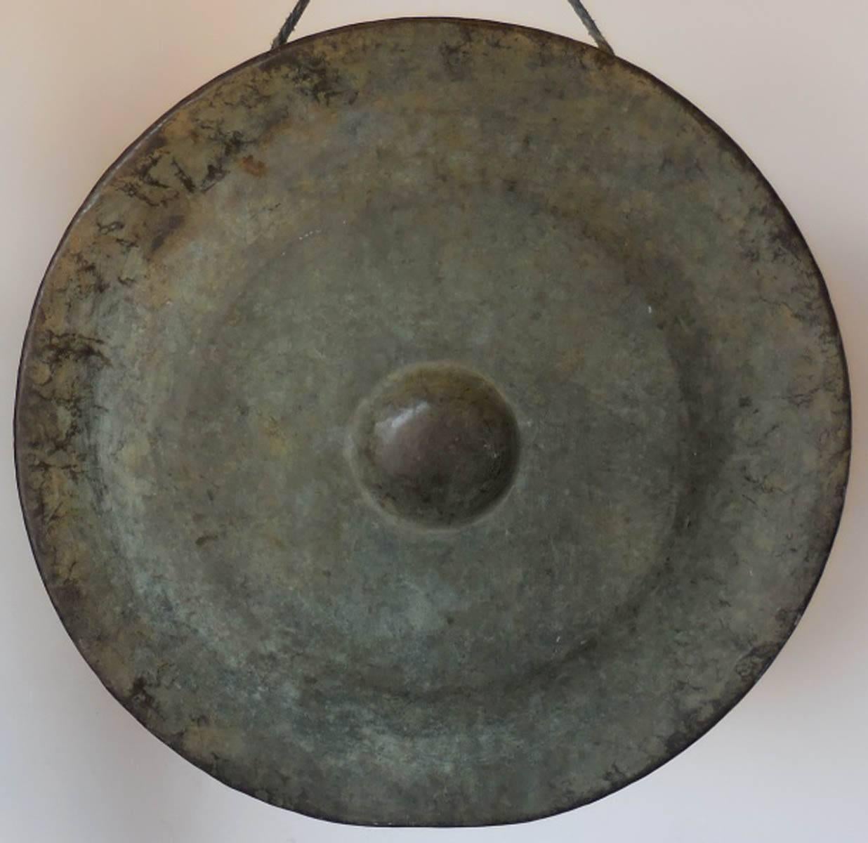 19th century Japanese solid bronze temple gong with striker. Simple design, beautiful sound. Lovely color variations of dusty of green, bronze patina. Wear consistent with use.
