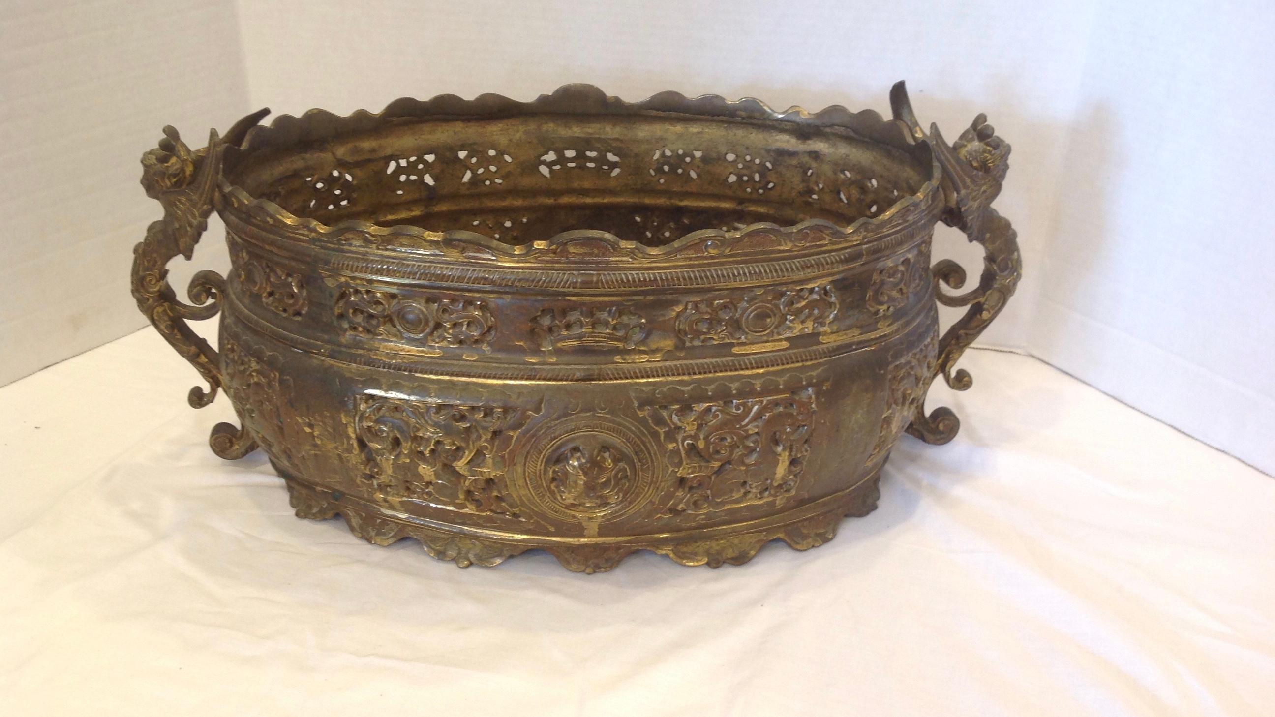 An elaborate continental planter is superbly fashioned with exterior pierced sides.
It is appointed with dramatic caryatid handles.