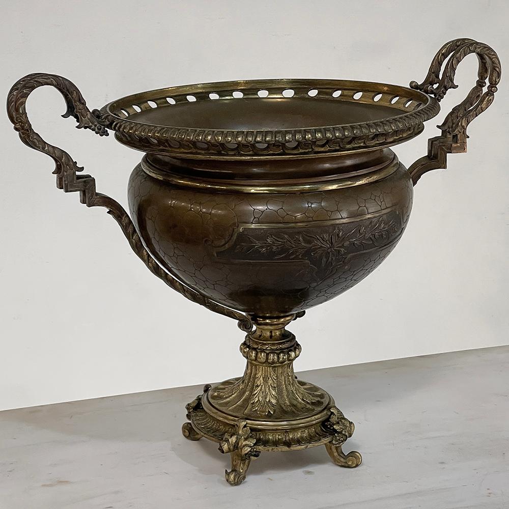 19th Century Bronze Jardiniere features a classic design inspired by ancient Greek and Roman architecture, with a generous coupe that can hold your centerpiece design for all to appreciate!  Generous, lavishly styled handles complement the