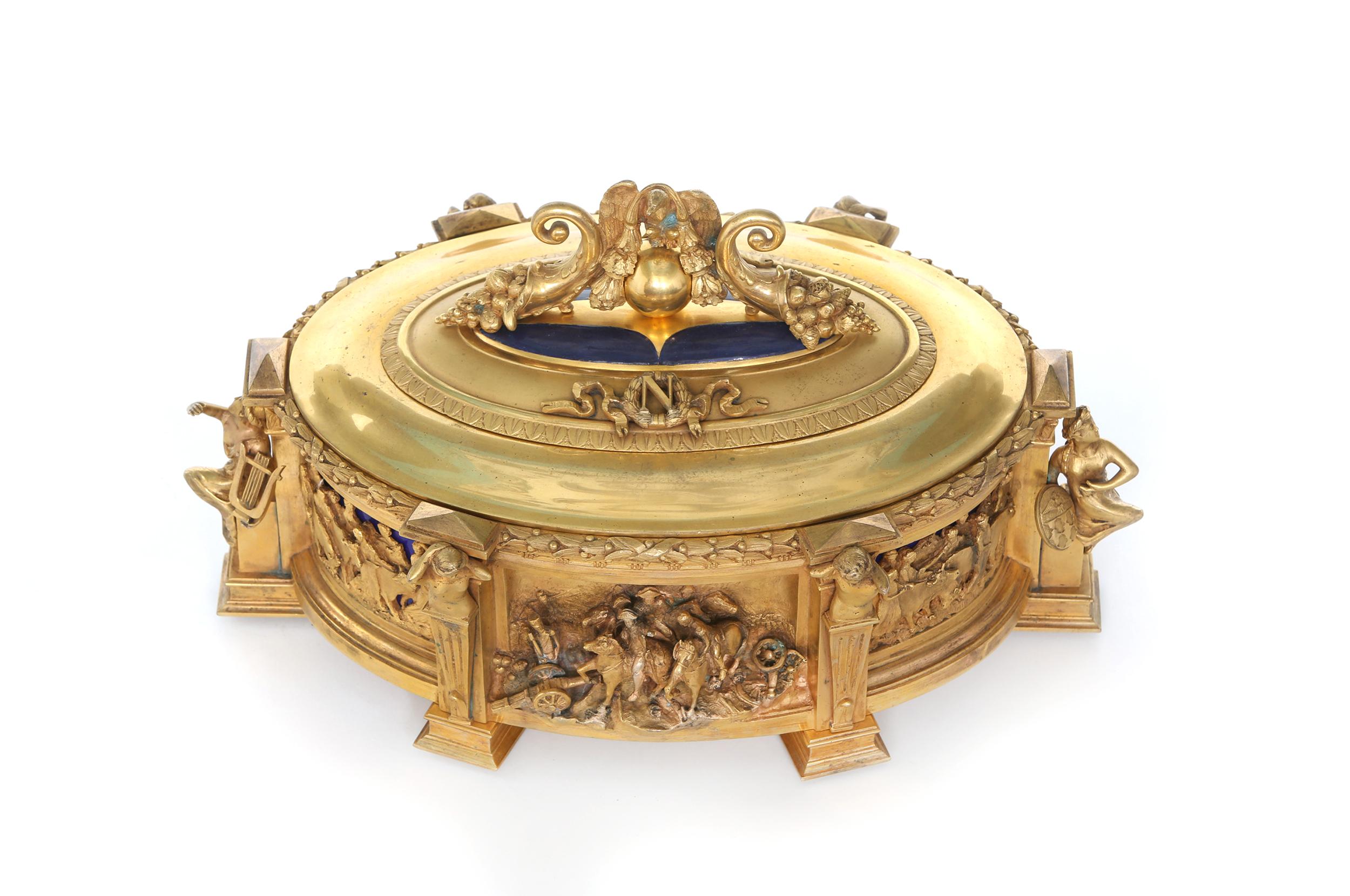 Mid-19th century gilt bronze with lapis lazuli covered top oval shape centerpiece box / decorative piece with exterior design details of Napoleon leading his men on horses. The centerpiece is in great antique condition. Minor wear consistent with