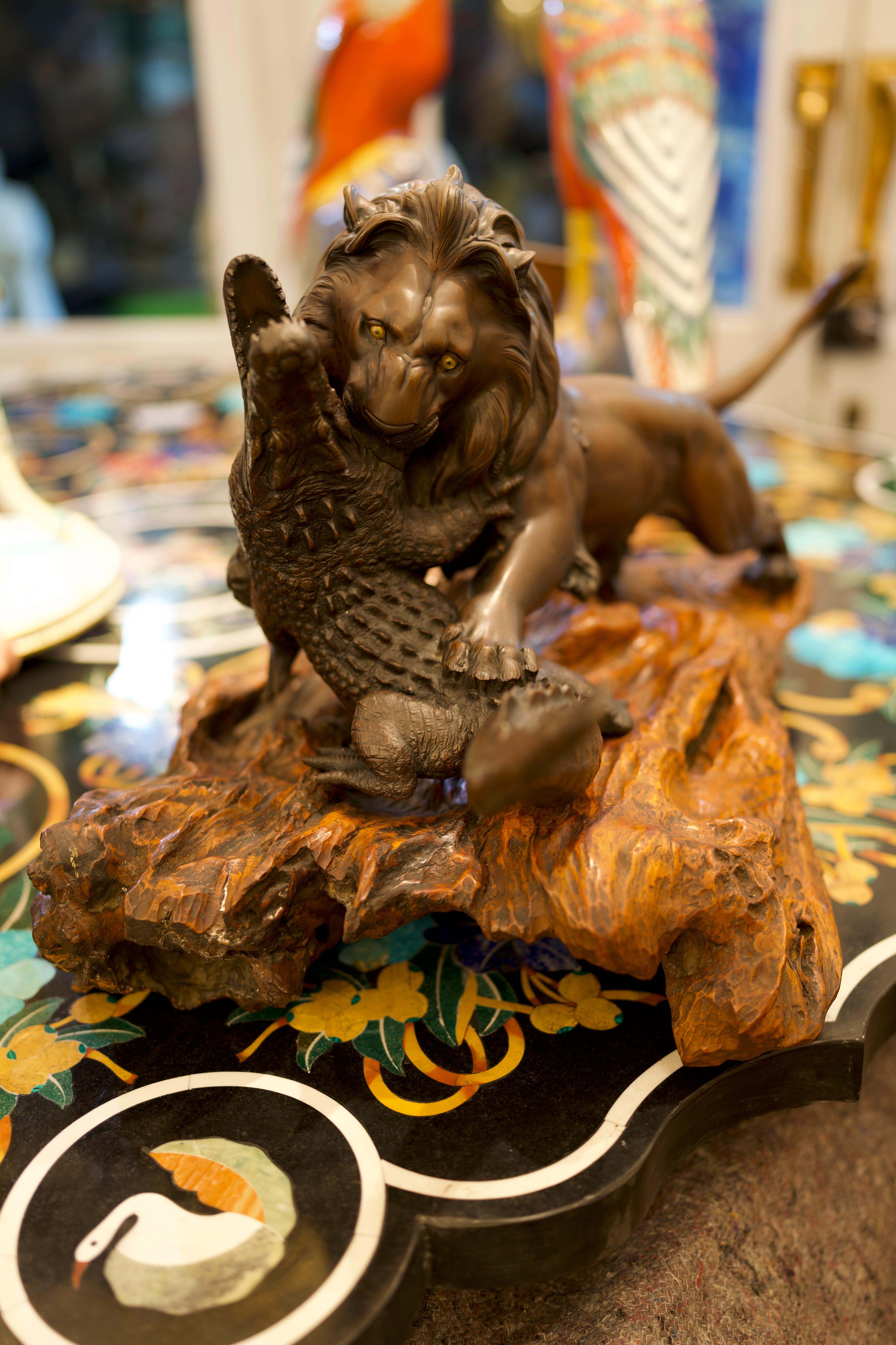 A Stunning 19th Century Bronze lion And Crocodile on Hardwood Base. The artist has illustrated a powerful image and captured the strength and power of the two beasts. 