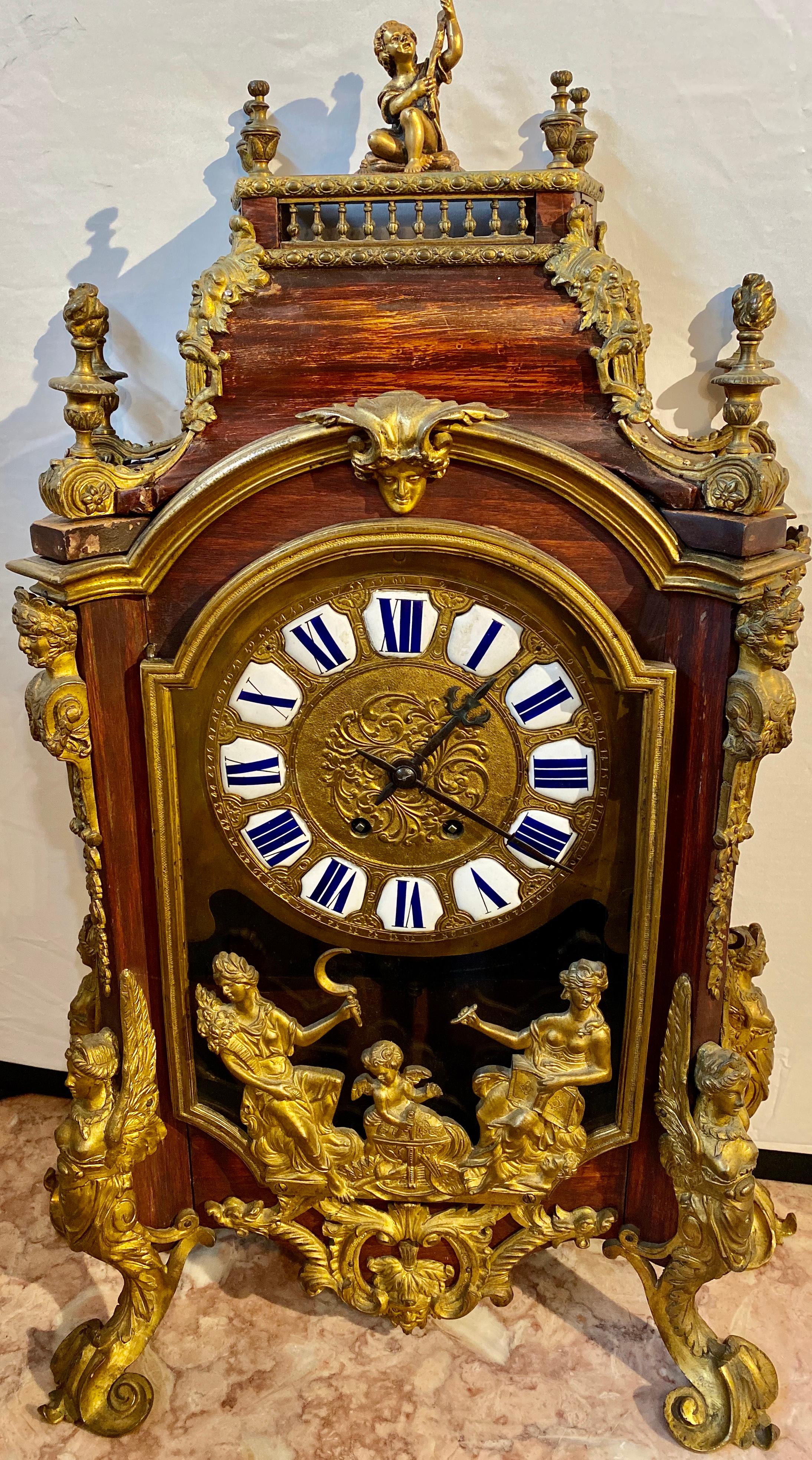 19th century bronze mounted mantel or desk clock figural. This fine working walnut clock is a must have for anyone looking to make a statement. The gilt metal or bronze mounts having multiple design such as female busts, ball and claw feet, satyr
