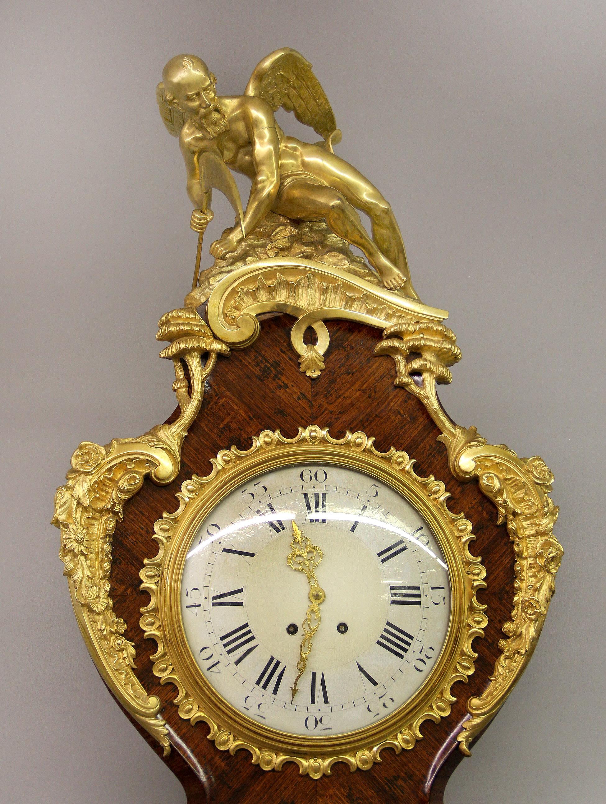 A superb late 19th century gilt bronze-mounted Regence style parquetry Regulateur De Parquet

By François Linke

The serpentine-shaped case surmounted by a figure of Chronos, the head centered with a black and white enamel dial and surrounded