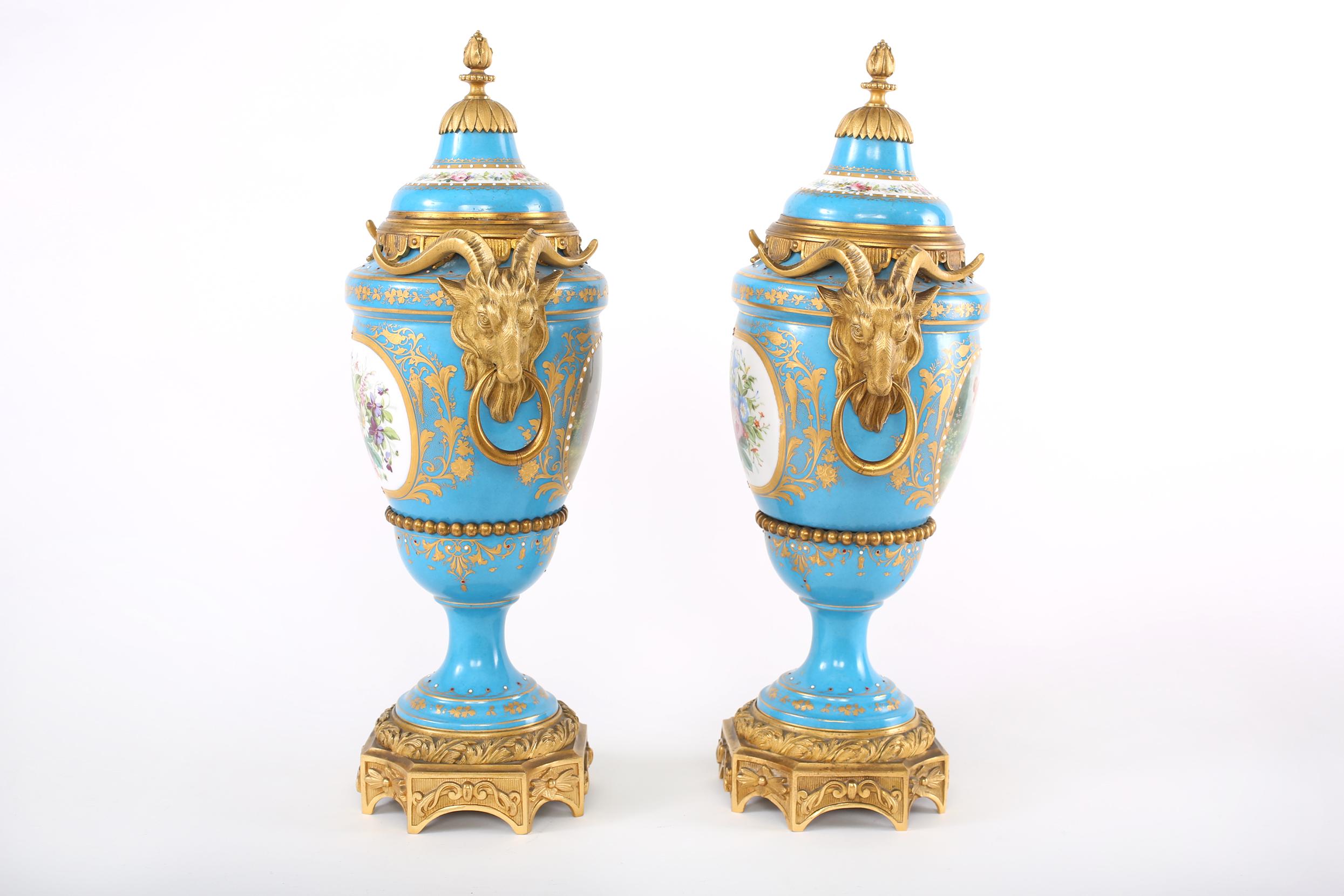 19th century French Sèvres-style porcelain gilt bronze mounted covered decorative urns / vases with gilt gold painted scene design details. Each urn is in good condition with wear consistent with age / use. Maker's mark undersigned. Each piece