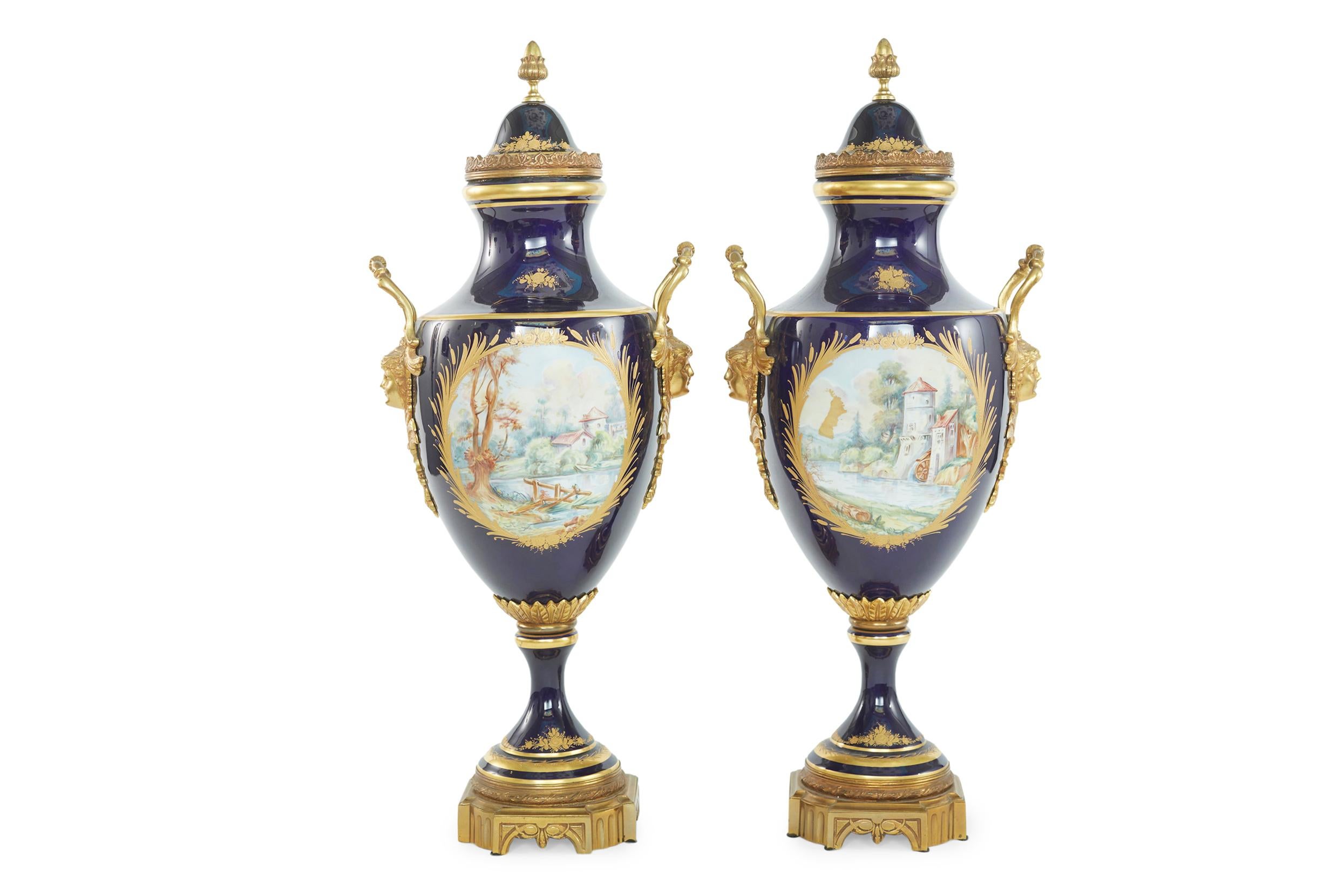 19th Century gilt bronze mounted Sevres porcelain decorative enameled covered pair of urn. Each urn features exterior hand painted scene details by 