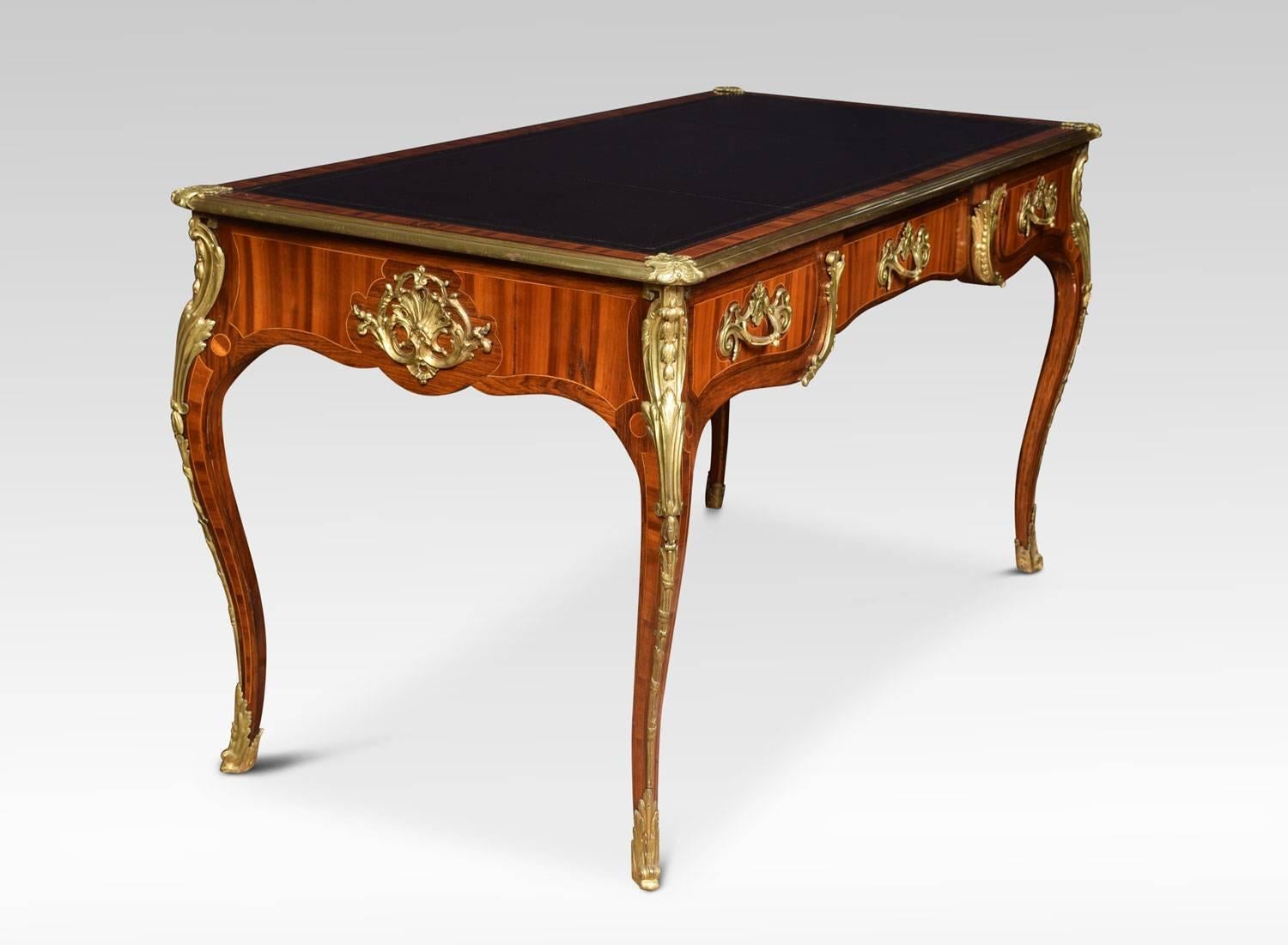 19th century bronze-mounted tulipwood and rosewood crossbanded bureau plat, the shaped top with gilt bronze border and tooled black leather inset writing surface above three frieze drawers, the reverse similarly decorated with false draws, raised up