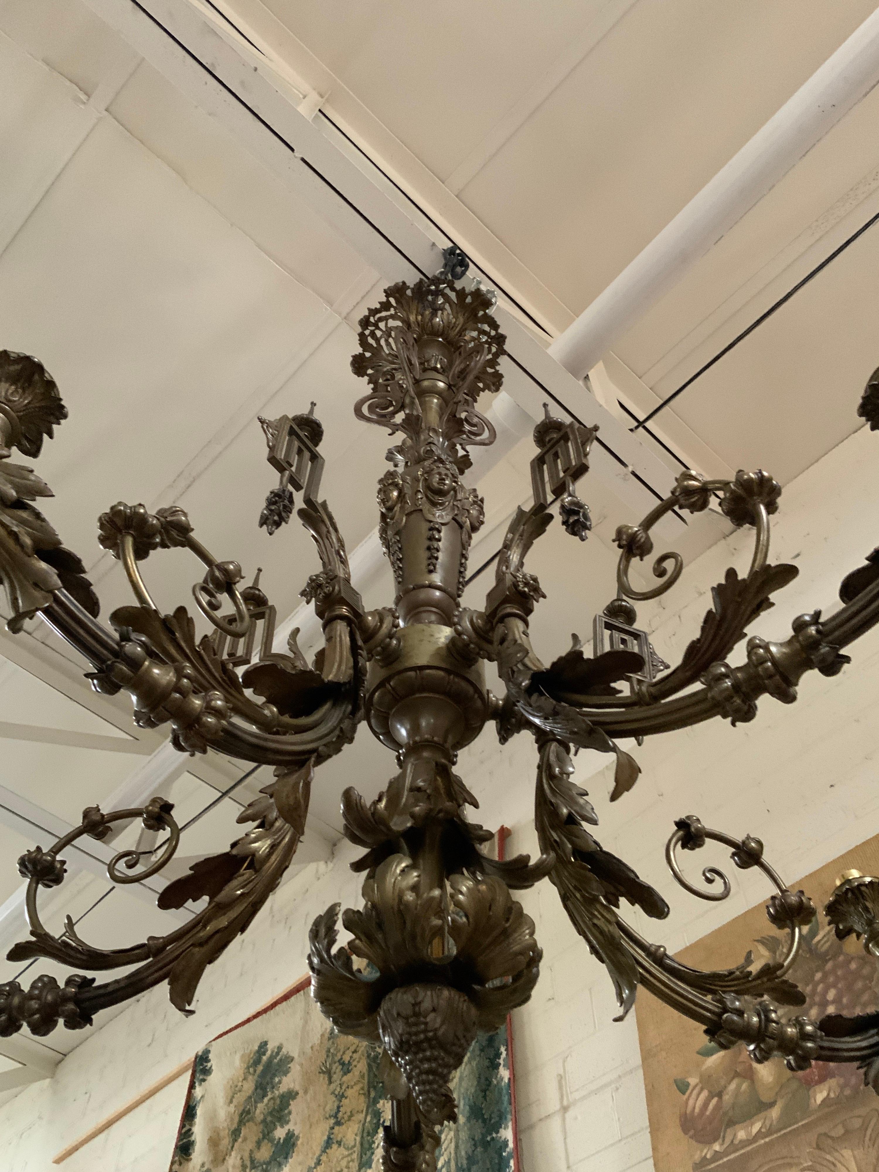 This gorgeous chandelier measures roughly 60 inches in height. Item features angels on the center stem and vine detailing along the edges. imported from Paris.