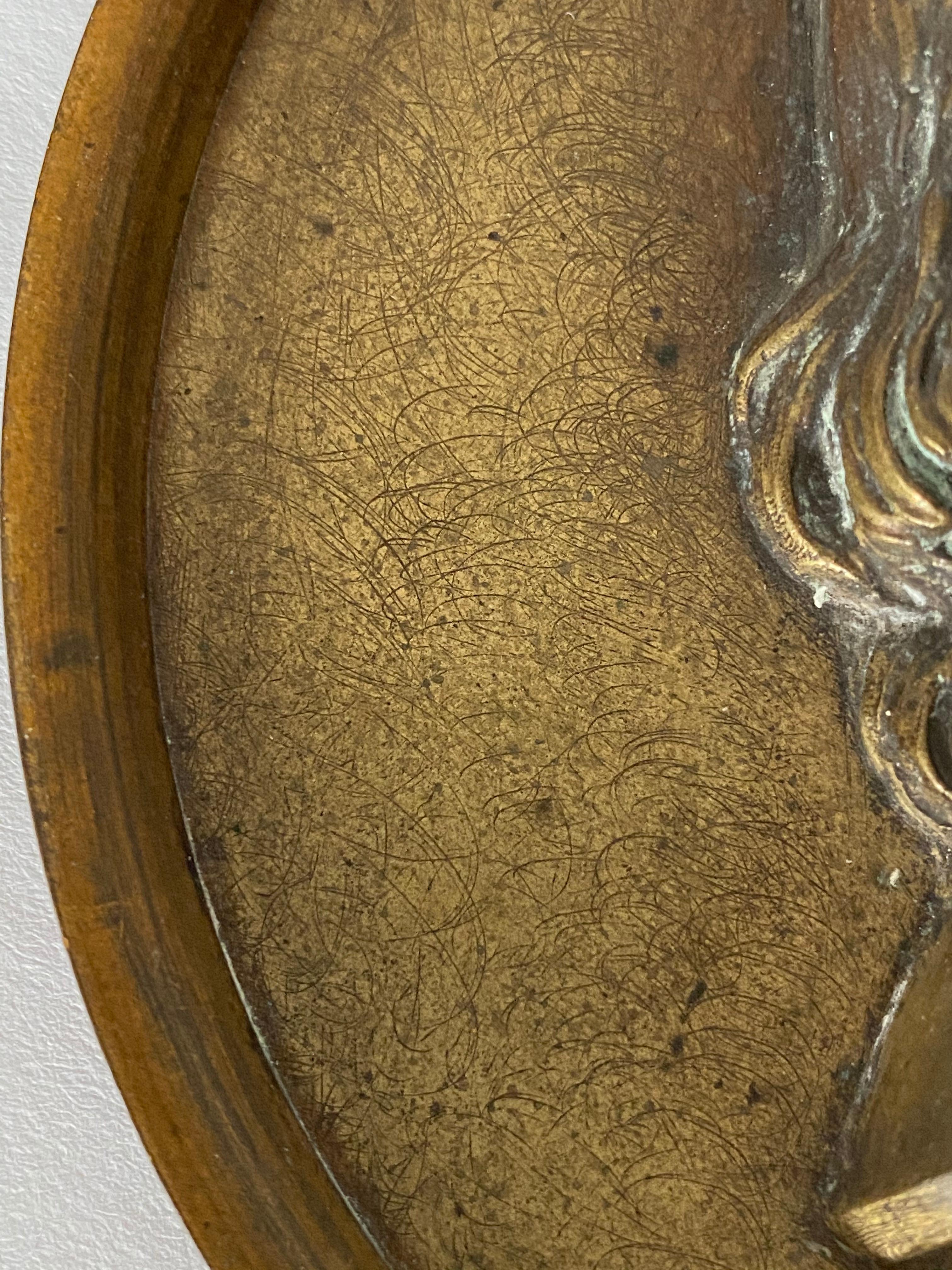 This rare profile relief depicts George Washington with unbraided hair.
There are no inscriptions. A separate bronze frame is attached with small screws from behind.

The modeler is unknown.