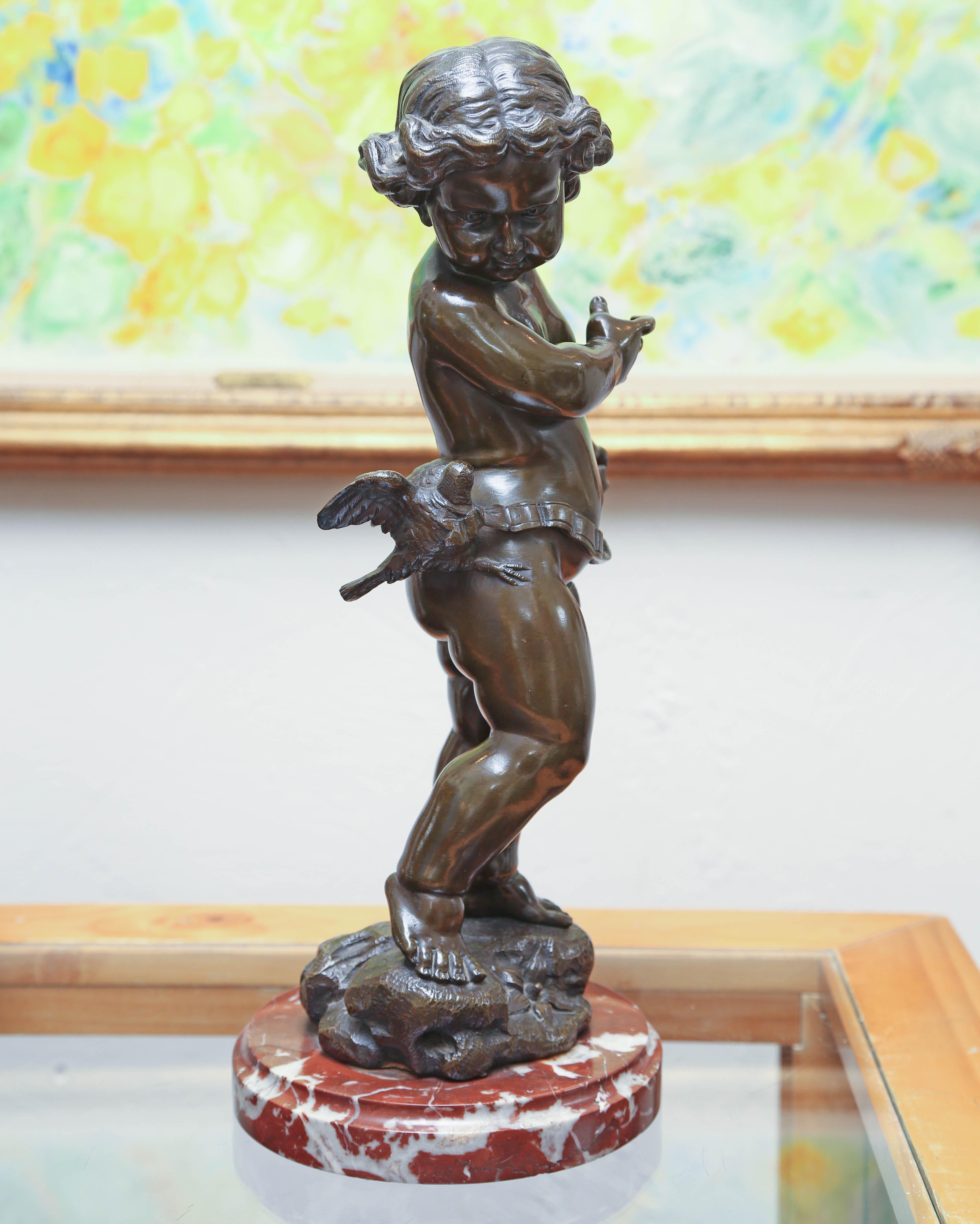 Venetian bronze putti by 19th century artist Valentino Besarel (1829-1902). Putti is standing on a rocky platform turning his head to glance at a bird resting on his hip. The bronze is mounted on a marble base.